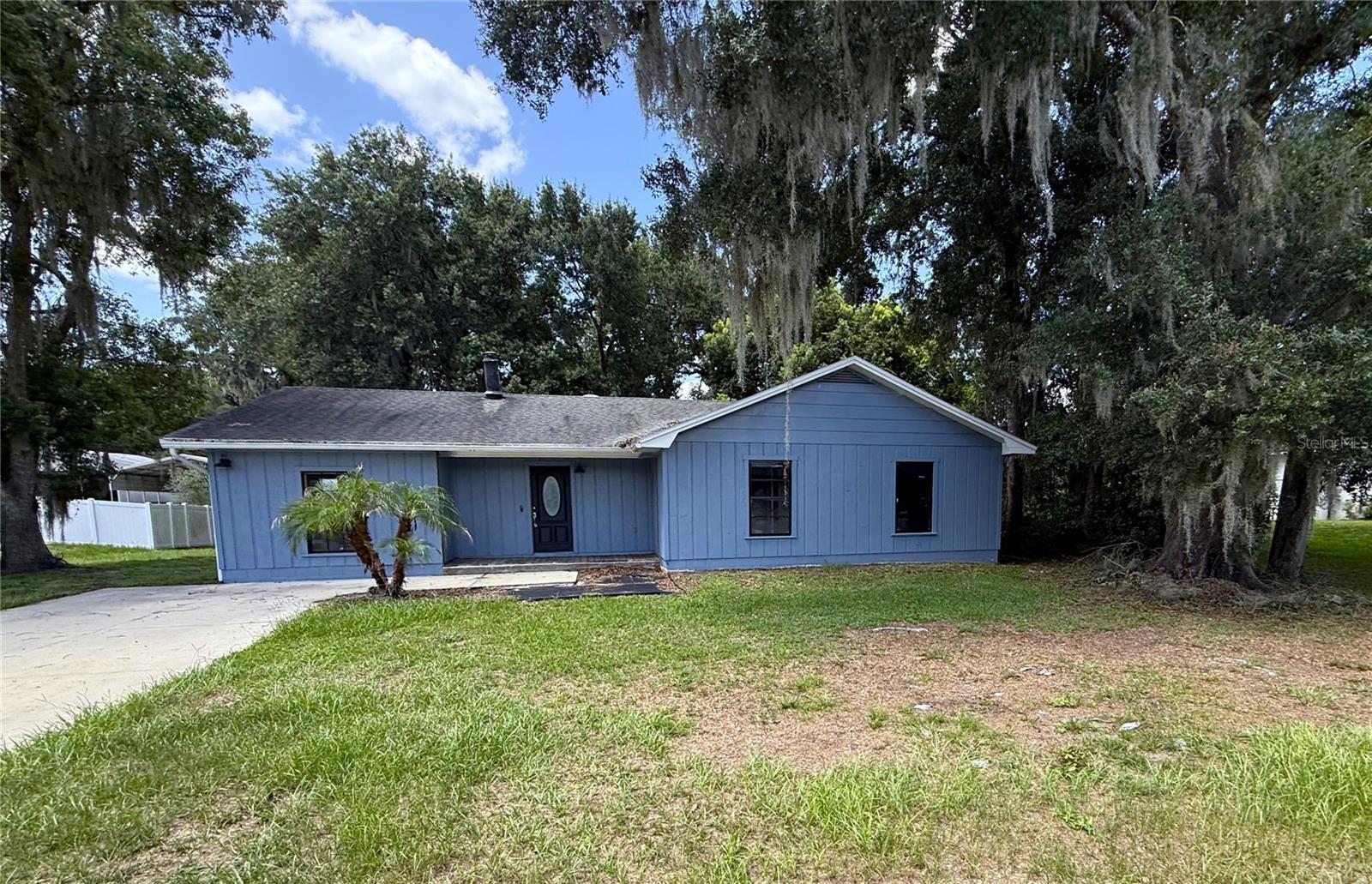 Enjoy the freedom of no HOA or CDD with this Lakeland home! Offering 4 bedrooms, 2.5 bathrooms, 1,573 square feet of living space, and situated on a large ¾-acre lot, this property is ready for its next owner. Step inside to a spacious living room with wood burning fireplace that flows easily into the dining room and kitchen. The kitchen features plenty of cabinet and counter space, closet pantry, modern backsplash and two pass throughs to the living/dining area with eat up bar seating. French doors from the living room lead to a patio and your private backyard oasis. A spacious utility room is directly off the living. Just at the front of the home, find the primary suite with built in closet, full bathroom with step in shower and vanity. A hall off the kitchen leads to the secondary bedrooms sharing a full bathroom with a bonus 1/2 bathroom off one of the secondary bedrooms. Great central location with easy access to I-4, shopping, dining, and everyday essentials. It's good to be home. This property may qualify for Seller Financing (Vendee).