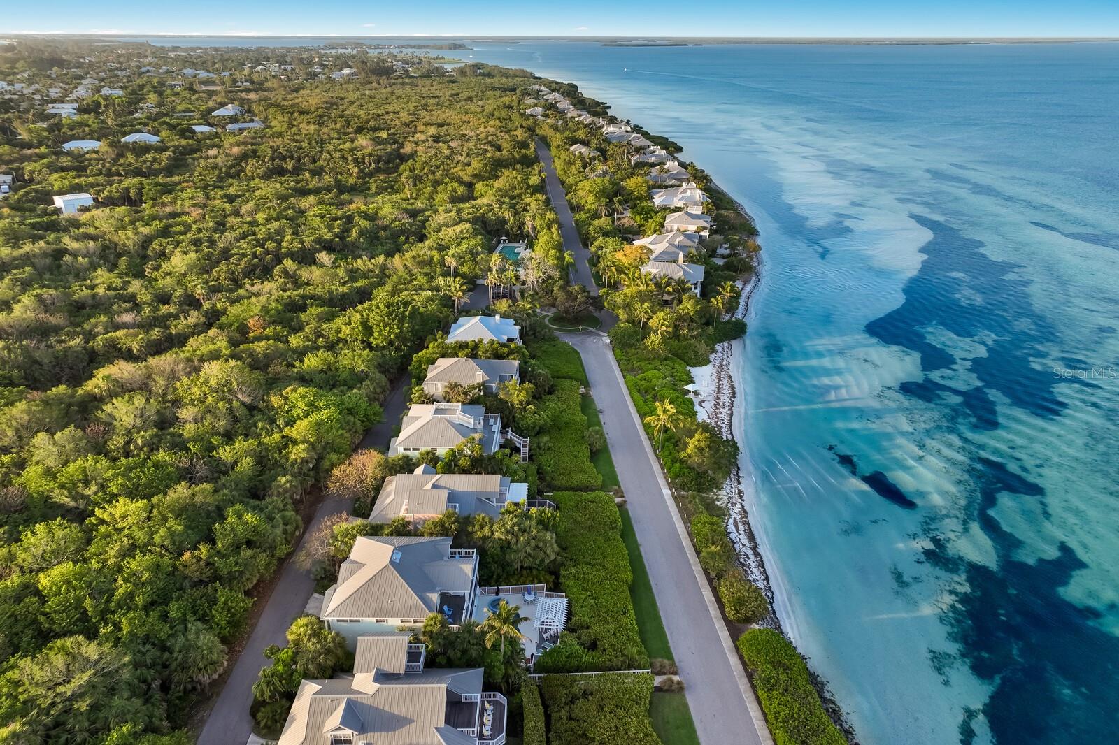 Welcome to 521 Buttonwood Bay Drive, a beautifully reimagined 3 BR / 3 BA coastal retreat with over 3,000 square feet in the exclusive, gated community of South Bay, Boca Bay, on Gasparilla Island. This exceptional single-family residence offers the kind of views, privacy, space, and elegance rarely found at this price point, making it one of the most compelling waterfront values on the Island. Beyond the private, guarded entrance of North Village in Boca Bay, ideally located just south of town in the heart of the Village of Boca Grande, a sense of serenity takes hold. As Boca Bay Drive winds past the pickleball courts and croquet lawn, manicured grounds, and beneath the canopy of mature banyan trees, the island reveals a hidden enclave few even know exist. This private and exclusive east island corridor offers a secluded tropical ambiance, quiet waterscapes, nearby lap pool, and a private beach perfect for sunbathing, picnics, or to launch your kayak or paddle board. Mornings bring a rhythm of joggers, cyclists, and dog walkers; evenings offer peaceful golf cart rides to the fishing pier or the Pass Club. Open your doors, and all you hear is the gentle lapping of the water and the breeze, pure island tranquility....worlds away from the everyday. Thoughtfully designed with timeless coastal sophistication, this elevated award winning floor plan called the “Licuala” blends classic old Florida charm with modern luxury. An expanded, sun-drenched floor plan invites you to relax or entertain in style, with an open concept living area that includes two waterfront sitting rooms and dining area, perfect for enjoying the spectacular water views. Prepare your meals overlooking the sparkling blue waters of the Harbor in your chef’s kitchen featuring high-end Sub-Zero and Thermador appliances, custom cabinetry, and a layout that flows effortlessly into the heart of the home. Outside, an oversized waterside Ipe deck creates the perfect backdrop for alfresco dining, sunset cocktails, or simply soaking in the coastal breeze. Rich hardwood floors in the main living area add warmth and character, while impact-rated sliding glass doors and electric exterior shutters provide enhanced security and peace of mind. Behind the main living space there are two spacious guest suites with private views of the State Preserve. The top floor is dedicated to the primary suite, a true sanctuary with its own private exterior deck, panoramic water views, and a private loft ideal for your home office, reading nook, or studio space. The ground floor features a two-car garage with golf cart space, ample storage, and a secluded screened porch surrounded by an orchid-filled garden. A nearby path provides easy access to the water’s edge. From your doorstep, enjoy effortless access to the very best of Boca Bay’s resort-style amenities including deep-water boat dockage, exclusive Pass Club membership, Gulf front dining, four sparkling pools, seven Har-Tru tennis courts, state-of-the-art fitness center, private fishing pier, and an elegant Gulf-front beach house for special gatherings. Whether you're seeking a full-time residence or seasonal escape, 521 Buttonwood Bay Drive offers the rare opportunity to own a luxurious single-family home with breathtaking views in one of Florida’s most desirable and private waterfront communities at a fantastic price point.