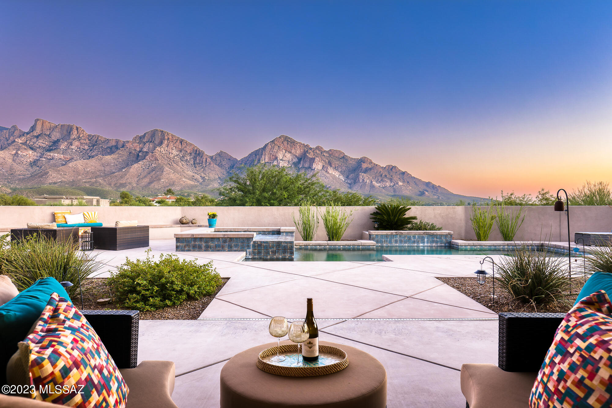 Sensational great room style custom contemporary built by Sombra Homes captures sweeping Catalina Mountain views! Fabulous outdoor living: relaxation/entertainment-oriented enclosed private yard, inviting self-cleaning spa & pool with soothing water feature, delightful firepit seating area, built-in BBQ, extensive deep covered patio. Impressive curb appeal augmented by professional landscaping sets an inviting tone for this meticulous 2,655 SF single-level 3 BR, 3 BA home with Office/Den & 3-car garage. Set on elevated half-acre lot bordered by open space with distance from neighbors, you'll be drawn by the panoramic views and charmed by the comfortable modern luxury design with scored concrete flooring throughout, split layout, upscale kitchen and spa-like primary suite. SIMPLY SPLENDID!