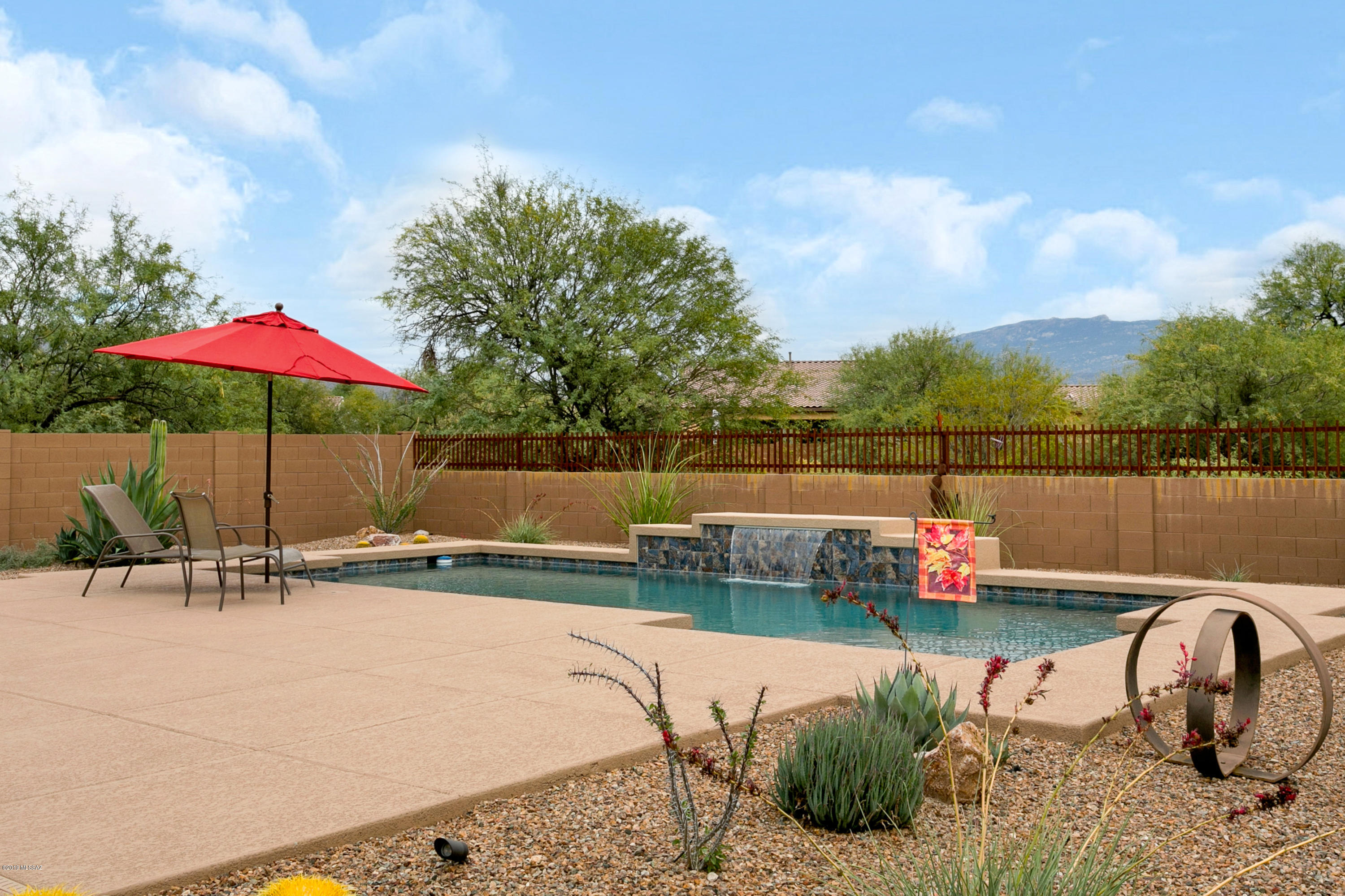 This is it ! Hard to find, home built in 2017  in a gated community in Tanque Verde Valley. This gorgeous upgraded 3 bdrm/den (can be  4th bdrm), 3 bath home is situated on a .48 acre with  mountain views & beautiful  patio  with heated pool for entertaining. Large great room w/niches for your art display & 3 panel door glass slider for inside/out entertaining. Gourmet kitchen opens to great room , with  premium cabinets, quartz countertops,  tiled back-splash, upgraded stainless steel appliances and walk in pantry. Formal dining room. Separate master suite  with  spa like bath & walk in closet. Perfect  laundry room w/sink. Upgraded tiled floors, designer window covering, fans & lighting. Split 3 car garage, 2 bay extended 2 ft for  larger suv & trucks, epoxy floors in both.