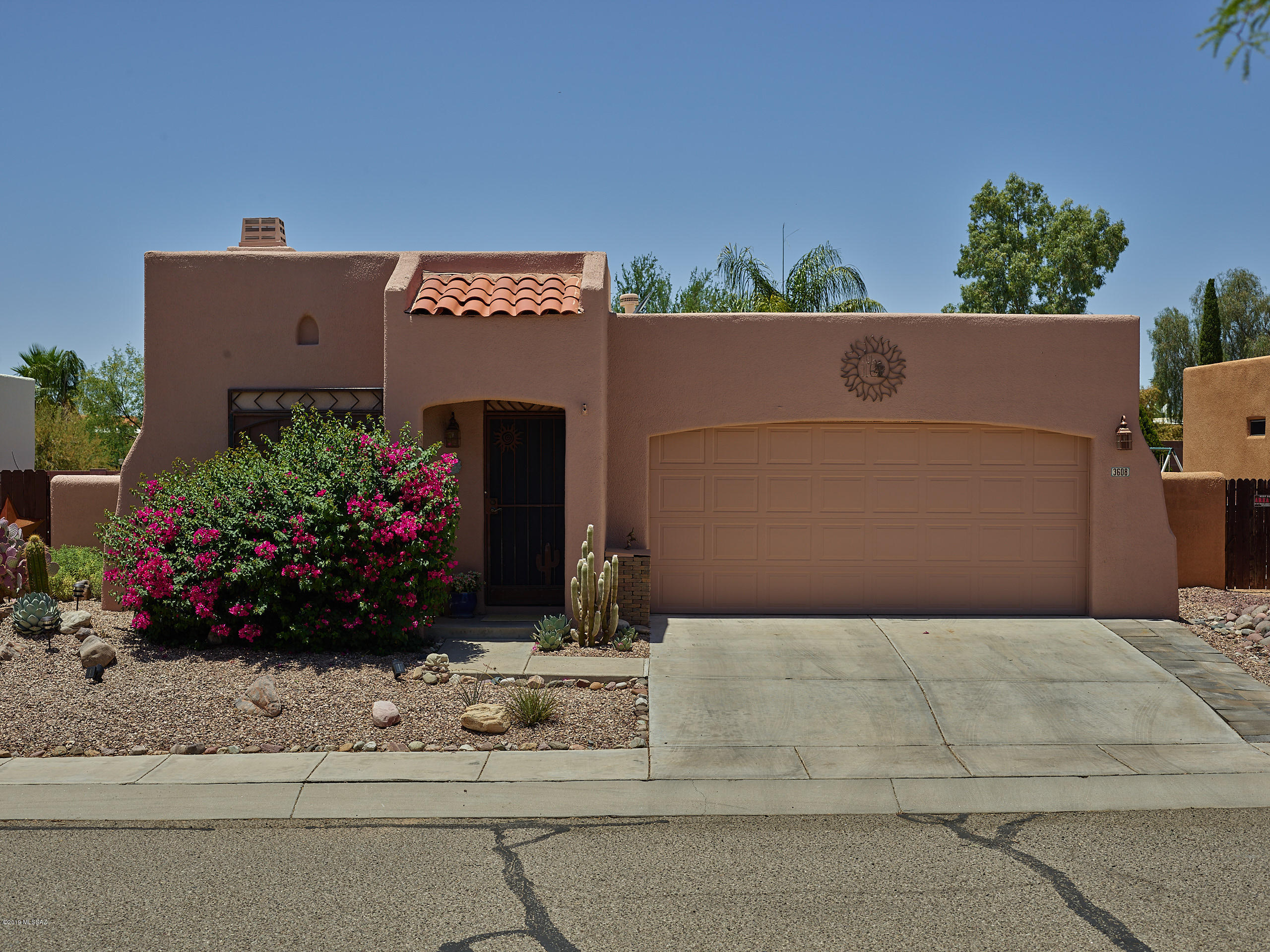 Range Price- Seller will consider offers between $259,000-$269,000. Completely customized 3 bedroom 2 bath Santa Fe home, with unique niches throughout, and an outdoor oasis! Large family room, with vaulted ceiling and wood beams. Cozy up to the wood burning fireplace. Skylights for added natural light. Ceiling fans. Stainless steel appliances in kitchen, two tone cabinets and beautiful granite countertops. Both Bathrooms have designer touches you will love. The over-sized back yard with mountain views, covered patio, flagstone, extensive landscaping and heated pool is perfect for entertaining. Make this your desert oasis today!