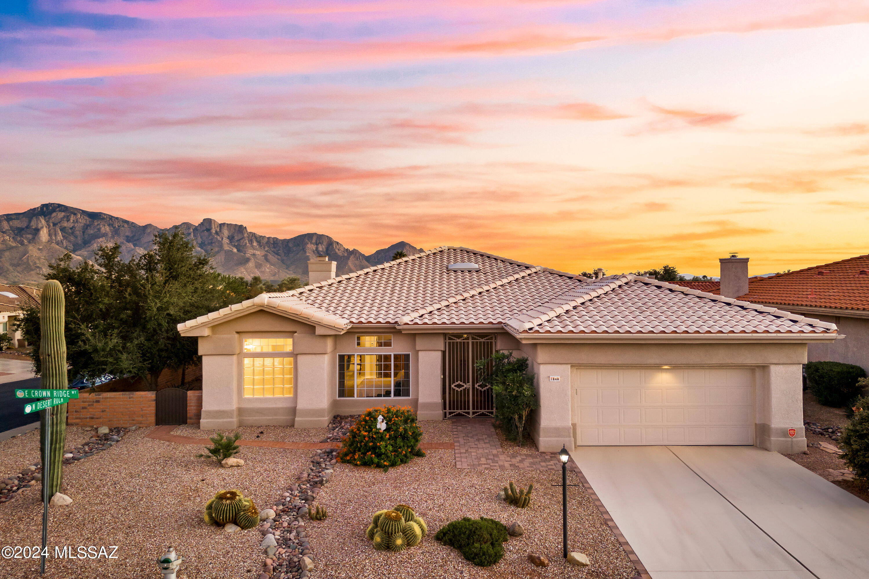 Sun City Oro Valley Mountain View Model Home with Catalina Mountain Views! Situated on a corner lot, this stunning 2,046 sq. ft. 2BR, 2.5 BA home includes spacious Office / Den & Laundry Room. The Open Floorplan captures the breathtaking Catalina Mountin views, creating a serene backdrop throughout the living areas. Enjoy gathering in the Top Quality Kitchen Open to Family room & eat in dining w/ a charming Gas Fireplace. Step outside to the gorgeous patio perfect for entertaining or quiet moments w/ nature where you can soak in the majestic mountain scenery. With it's modern finishes & prime location, this home offers the perfect blend of luxury and comfort in a vibrant community.  New HVAC 2023. Sun City amenities: 18 hole Golf Course, Pools, Fitness Ctr, Pickleball, Restaurant & Clubs.