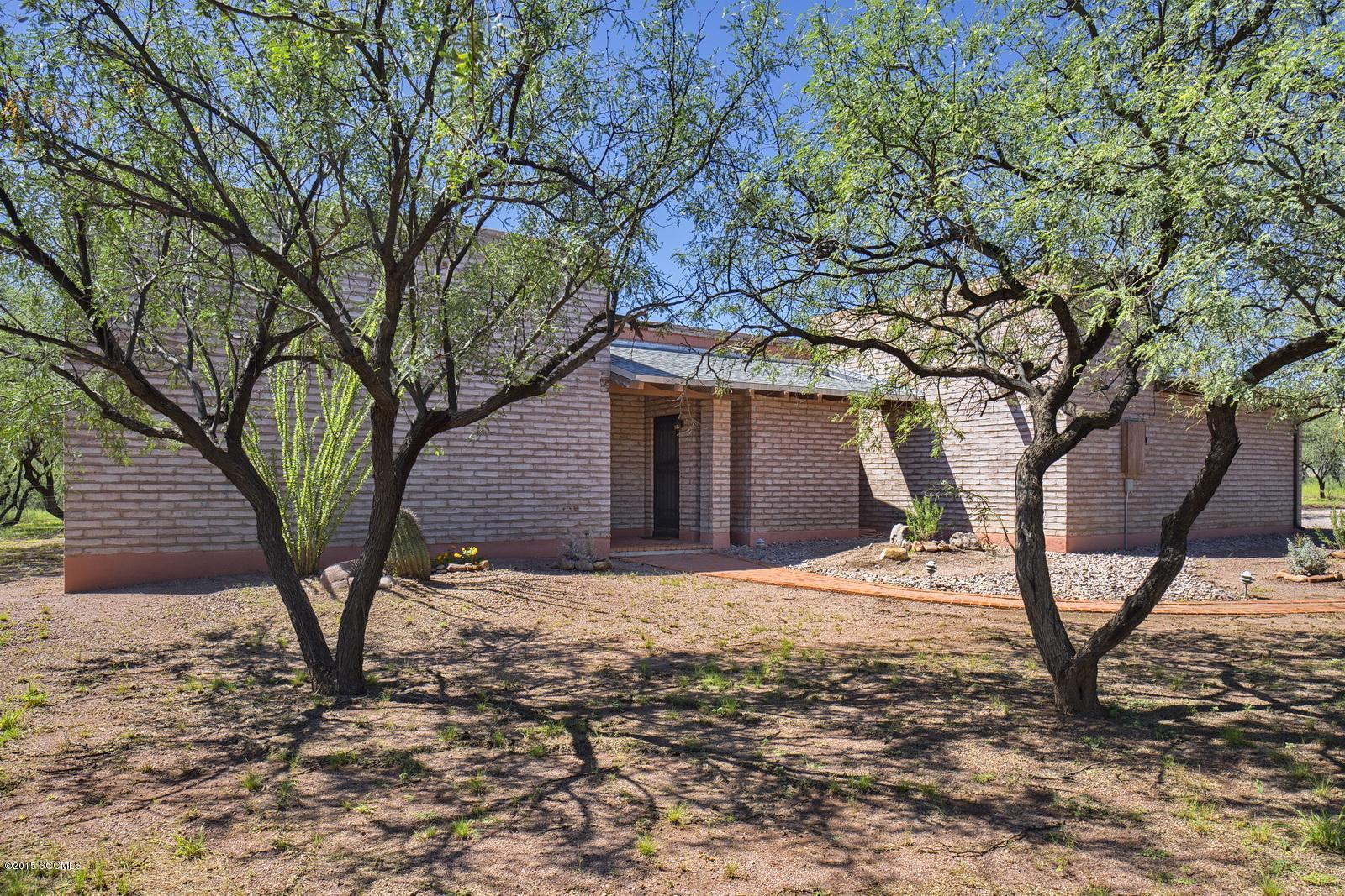 Located in Empty Saddle Estates this territorial style adobe home on 4.37 acres with three bedrooms and 2 baths is zoned for horses and has six separate fenced areas, many mesquite trees for shade and open mountain views.Inside you'll love the vaulted wood ceilings and red brick floors! The great room has a wood stove for those cozy Arizona winter evenings. Plenty of room to built a guest casita, also!