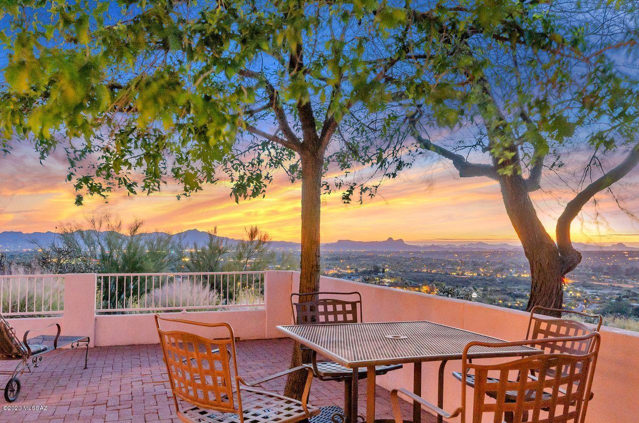 RARE PANORAMIC Mtn, Sunset & Night Light VIEWS! Even rarer opportunity to OWN such a prime property in Oro Valley's prestigious, manned gated, La Reserve, high atop The Ridge. Courtyard entry welcomes you into very comfortable 1512SF light & bright, high ceilinged living area, w/cozy fireplace & two walls of window views. TWO nice sized bdrms (one could easily be dual purposed), TWO separate dining areas, pass-thru bar & PRIME VIEWS from walk-out master bedrm, mstr bath, living & breakfast areas. Spacious covered & pavered wraparound patio w/180+ degree VIEWS. 2C gar w/2 walls of storage cabs & mini-workshop. Great year round living or extremely desirable vacation rental. One yr Full Home Wty coverage from Old Republic. Virtually all the furnishings & decor pcs available on separate BOS.