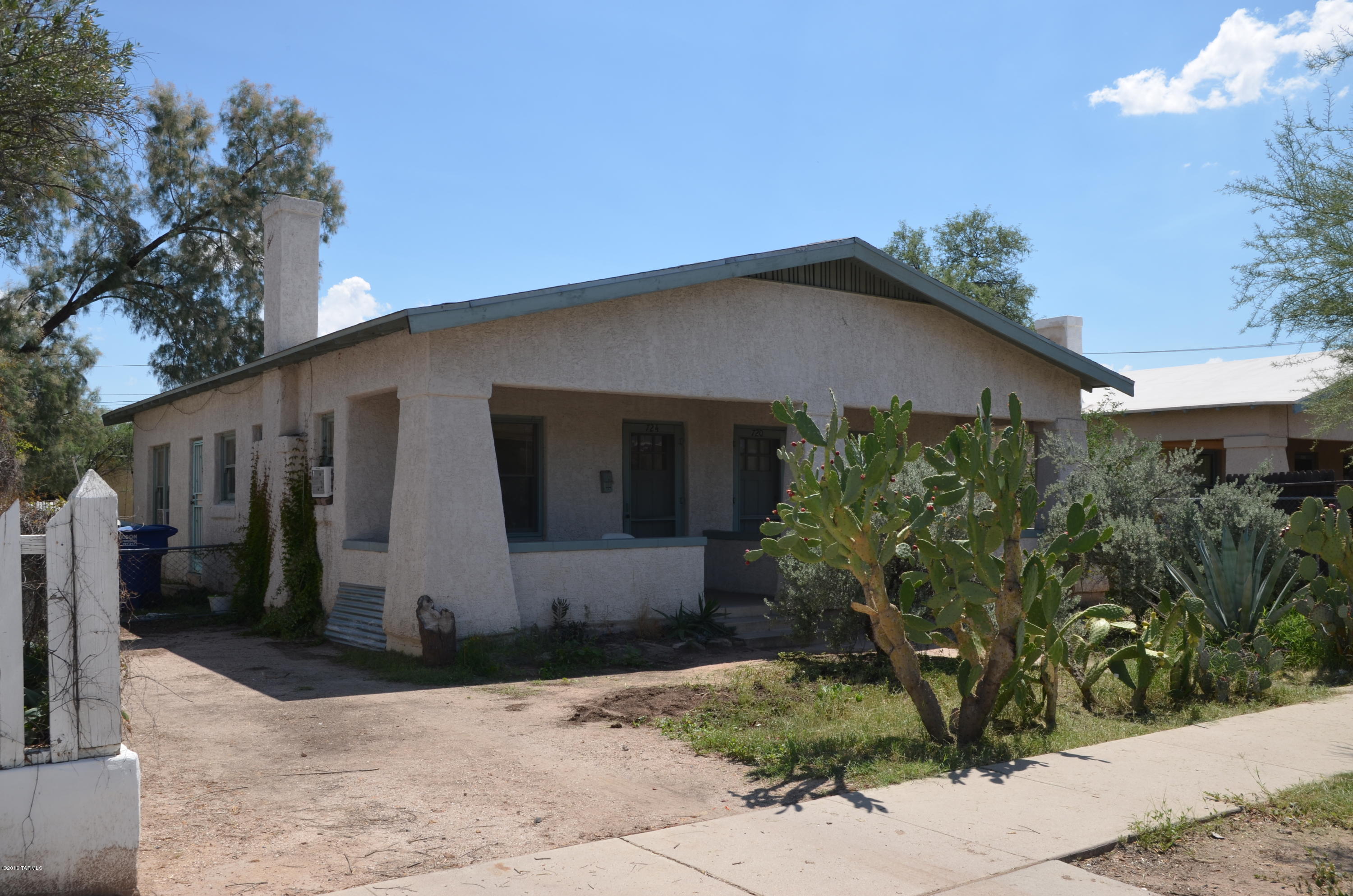 Charming and historic duplex-bungalow situated within 4 blocks of University of Arizona and downtown. Two 1 bedroom-one bath units.  Large eat-in kitchen. Large shared lot (8712 sf) with existing garden.  Interesting built-ins next to working wood burning fireplaces. Festive and artistic touches all over like the kitchen back splash in one of the units and an O'Keefe and Merit stove.  Sturdy concrete porches in the front of both units. Outdoor washing machine (gray water), no dryer.  Old school clothes line. 
The bell pipe connecting the two units to the sewer system needs to be replaced.  Other plumbing issues may need to be addressed. Being sold ''AS-IS''. CASH OR OWNER CARRY will be considered.  The rents have not been adjusted in over 5 years.