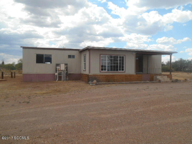 acreage that you have been waiting for! With some TLC you will soon be living in a 2 bedroom 2 bath with a den and family room. The neighborhood school is highly regarded and just down the street from this home. Just think that your children can experience country living like your grand parents did. And yet, you are 8 minutes to Interstate I-19 and 20 minutes from Tucson.