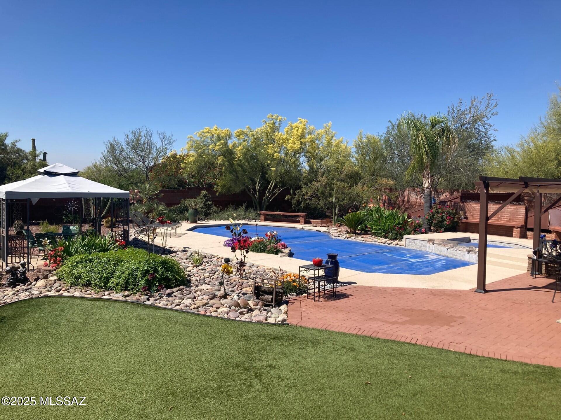 Seller will accept or counter offers between $650,000 and $675,000..A diamond in the desert.... A Beautiful property located in the very desirable Casas Adobes west.  1 acre completed fenced in. 3 Bedrooms PLUS a den and 3 bathrooms. Featuring updated bathrooms and Kitchen remodels with gorgeous cabinets, Granit Countertops and much more.  The addition of the Arizona Room is perfect to be able to enjoy the property even more.  A large Pool with spa, ramada and breath taking flowers all outback in this true desert oasis.  There is also several storage areas and workshops.  This is Truly a MUST SEE!!!
