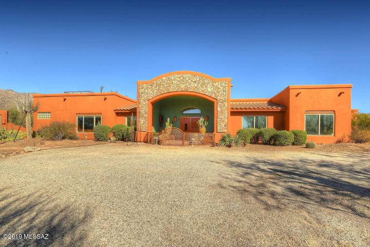 Seller will accept or counter offers between $600,000 and $625,000. You CAN have it all! Mountain views & saguaro studded 4-acre property make this tranquil Southwestern home your very own private retreat. 3 BD + Den/3 BA main house, solar heated pool/spa, outside fireplace & BBQ plus a 2 BR/1BA Guest House. Horse facilities include 2-stall shedrow barn w/tack room, hay storage & corral w/direct riding/hiking access to Aqua Caliente Wash. Enter through the handcrafted stone courtyard entry, high wood ceiling with vigas, windows w/views to the mountains. Eat-in kitchen and a large formal dining room. Living room has clerestory windows & 2 sets of French doors to the patio. Master suite also opens to the patio. Spiral staircase up to the rooftop viewing deck. Large 2-car garage with workshop. Tanque Verde School District. No HOA!