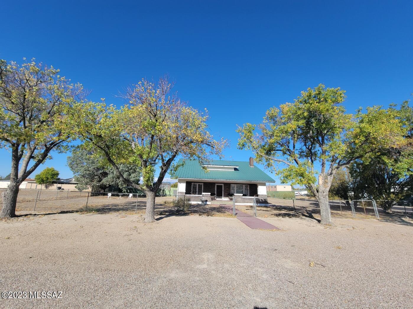 Beautiful Historic Carriage House in the heart of Willcox. This beautiful home exudes character and history. This 3 bedroom 2 bathroom home was built by the first Mayor of Willcox and the bricks were brought in from New Mexico by freight wagon. This home has been well cared for and is in amazing condition. Large city lot with mature trees. 2 car garage, 2 storage sheds/shops, green house. The yard is completely fenced. 1 car carport. Beautiful front porch to enjoy the amazing weather in Cochise County. This is a true show home.  Property also has solar panels. Historical home built in 1933 has been remodeled and includes many modern improvements. Metal roof, stainless steel appliances, corian countertops, porceline tile in the kitchen, fireplace in the living room, clawfoot tub in bathroo