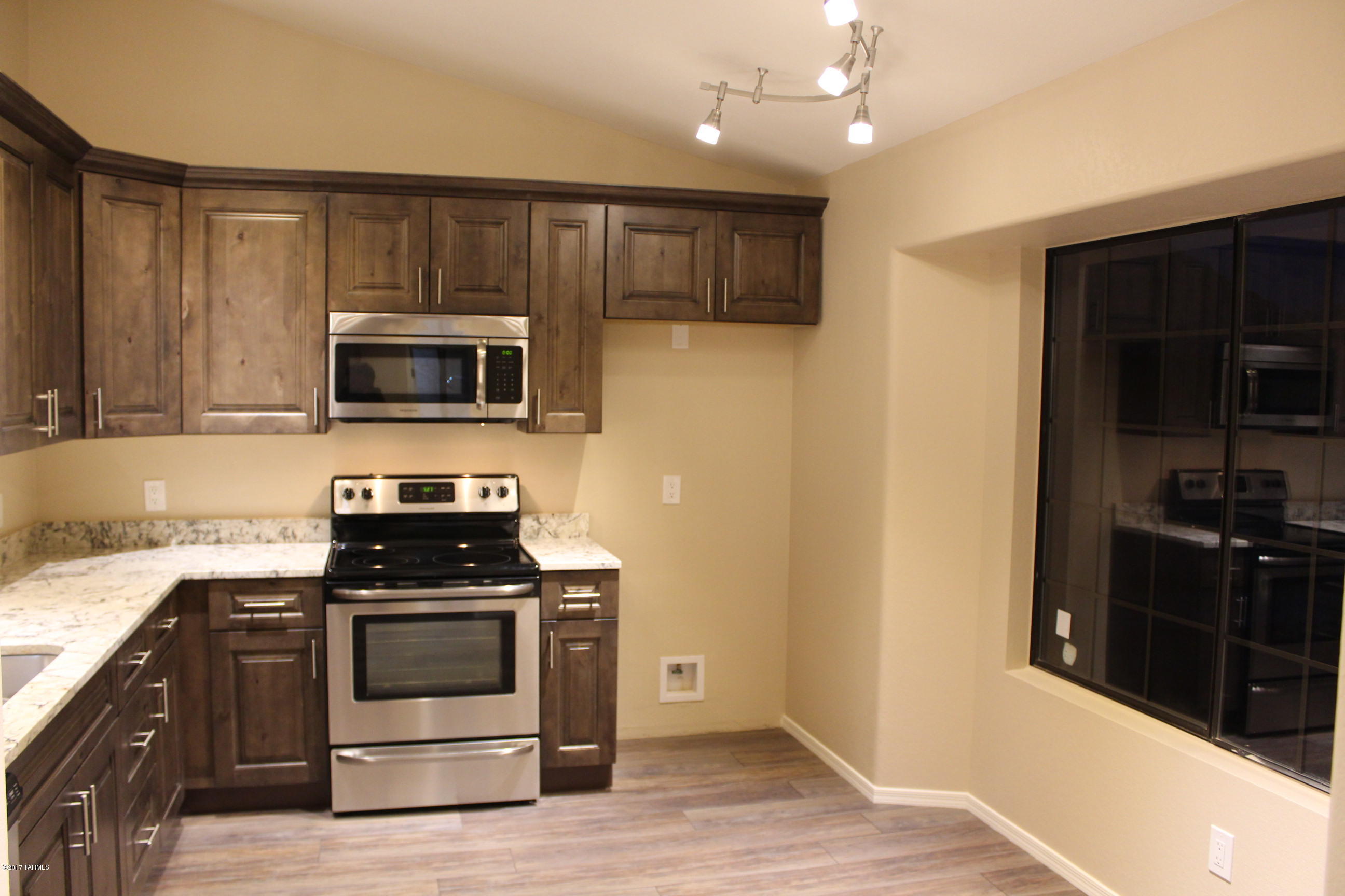 Amazing remodeled home in Stoney Canyon at La Reserve. Enjoy one of the most unique, private and friendliest places to live in Oro Valley.  Spectacular Pusch Ridge views from this gorgeous 2 bedroom, 2 bath TH. Directly across the street from the pool and ramada area, this cozy 35 home subdivision offers a private resort feel. Alder wood style cabinetry with soft close doors and drawers, all new fixtures and contemporary granite counter tops. You will love the custom tile flooring, open floor plan, vaulted ceilings and stacked stone fireplace. Executive height vanities and spacious master suite with huge shower. This home has been masterfully designed and offers a perfect blend of comfort and class with a modern feel. NO POLY! Member is a licensed real estate broker.