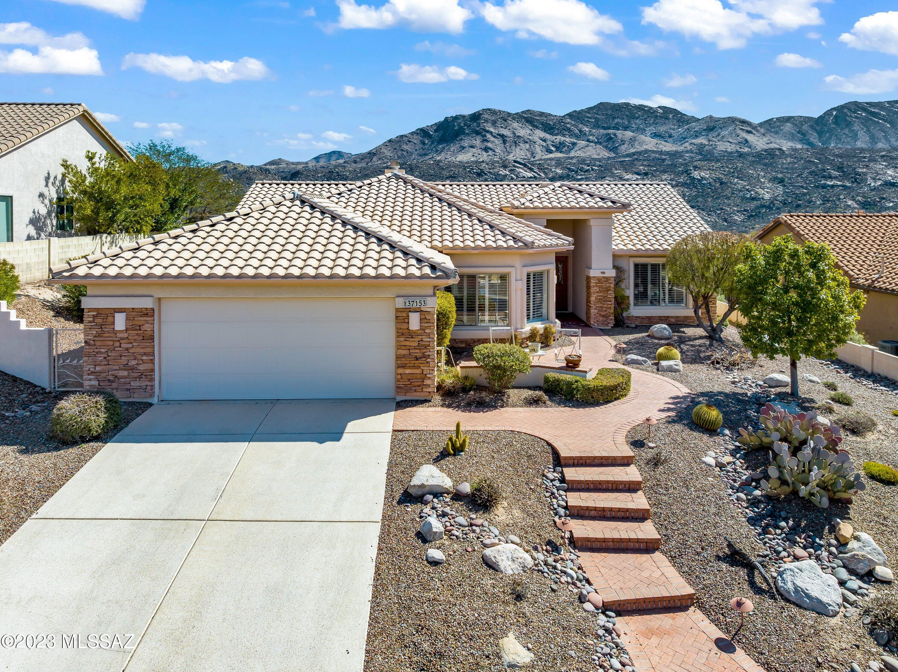 This stunning home boasts breathtaking panoramic mountain views that will leave you in awe. The extended garage provides ample space for your vehicles and storage needs. The vaulted ceilings and cozy fireplace create an inviting atmosphere perfect for relaxing or entertaining guests.  The large kitchen is a chef's dream with 42'' cabinets and roll-out shelves, providing plenty of storage for all your kitchen essentials. The large laundry room makes laundry day a breeze, and the spacious master closet is perfect for organizing your wardrobe. With so many features and amenities, this home is a must-see!