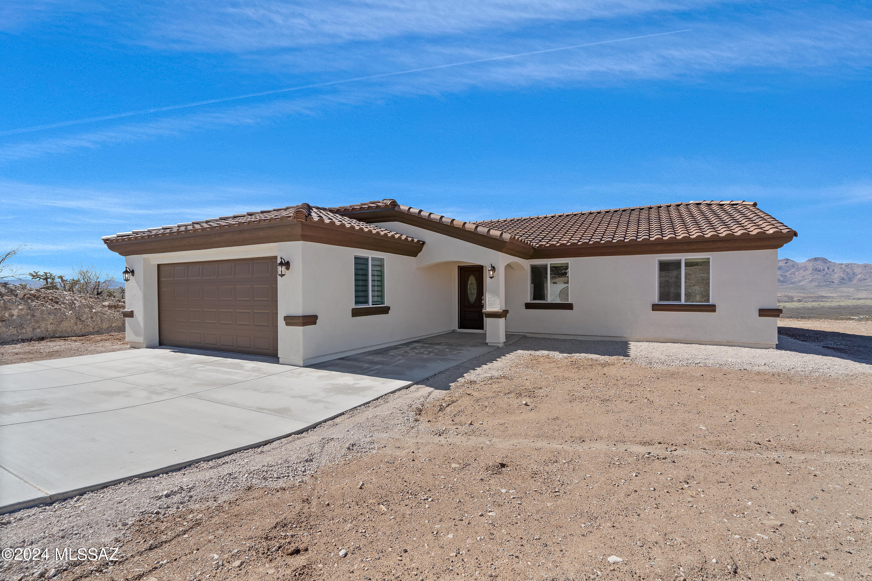 Experience the pinnacle of Rio Rico, AZ, living with this stunning, brand-new construction home. Boasting a thoughtfully designed floorplan, this residence features 3 bedrooms and 2 bathrooms accompanied by a convenient 2-car garage, all situated on an expansive 0.55 acre- acre lot offering picturesque mountain views.  From the moment you enter the home, you'll be captivated by the meticulous attention to detail and the seamless flow of the layout, creating an inviting and functional living space.  Currently, in the active stages of construction, this is projected to reach completion by the end of September 2024.  It promises modern comforts and beautiful finishes throughout.  Imagine waking up to the tranquil beauty of Rio Rico each morning, with the majestic mountains as your backdrop a and ample space to create memories.