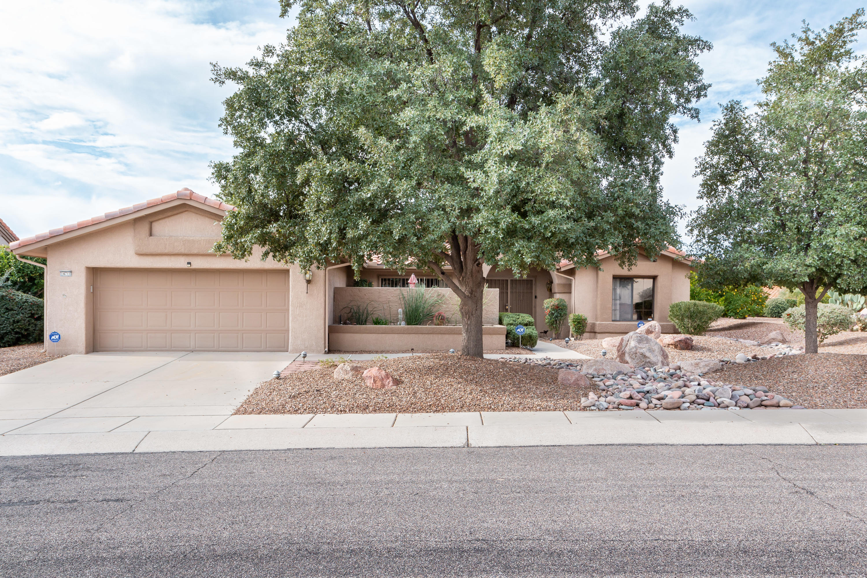 Newer roof & a 3 mountain range view from the back patio . Kitchen opens to the bright & light family room w/ a large window view of the Catalina Mountains!  Corian countertops, all newer appliances stay. The enclosed patio off the master  would be a nice area to sit w/ morning coffee, maybe put in a hot tub? Solar tubes keep areas light filled, ceiling fans, tile and carpet. Master bath w/separate  shower/tub. . Front room used as office, furniture can stay. Nice updated shower in second bath, split bedrooms, high ceilings. plus a 602 sq.ft.  bonus room.w/ a wall of windows for natural light & mountain views, enjoyed by sellers as a nice gathering area, heated & cooled w/ a high efficiency mini split, not included in the main house sq. st. Or a hobby room? Large bookcase can stay, some furniture available on separate bill of sale or with an acceptable offer.