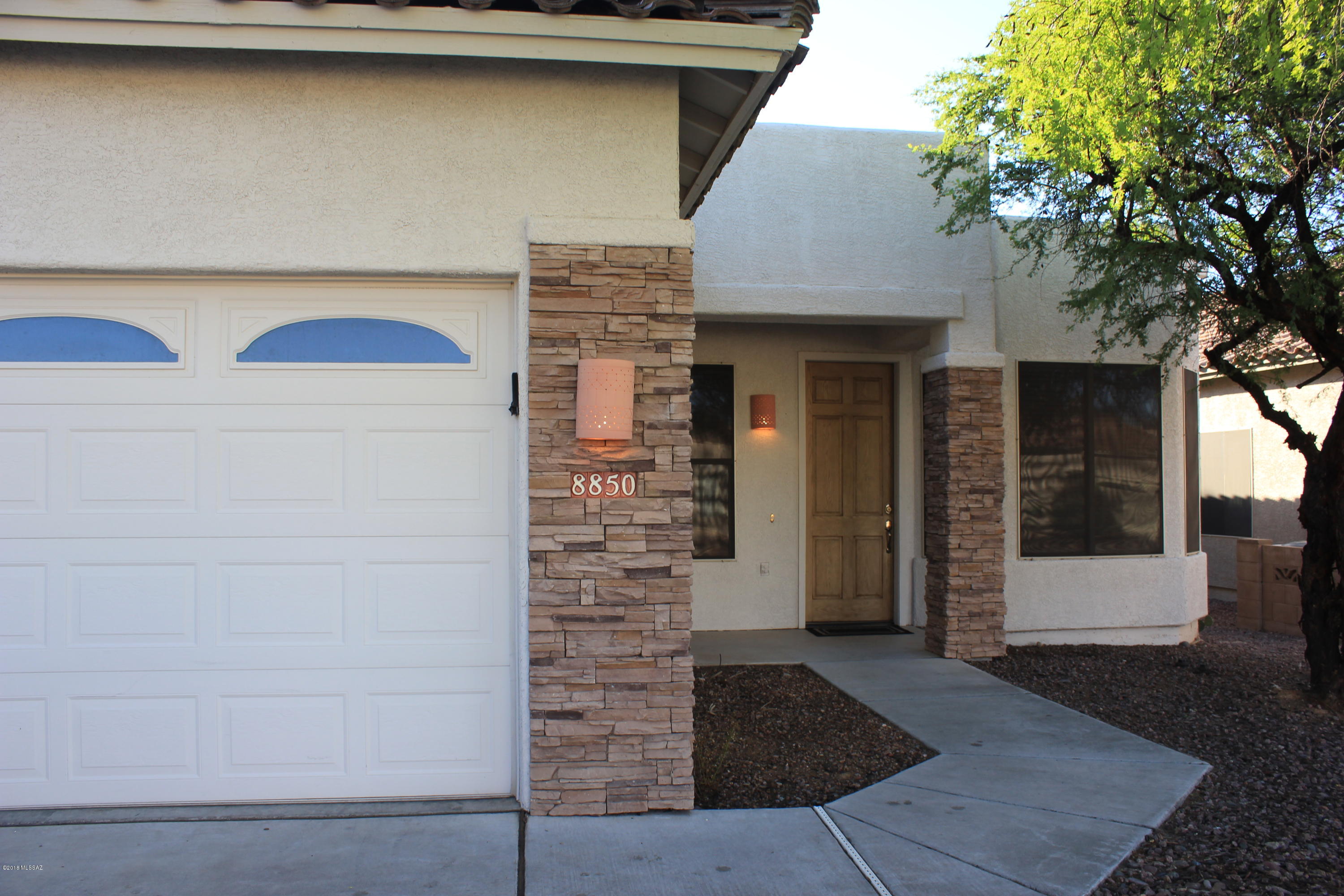 Outstanding home behind the gates at Reflections at the Bluffs.  This 4 bed 2 full bath home features wonderful architectural detail with soaring ceilings and lighted fans throughout.  Rich ceramic tile in all living areas & warm wood flooring in bedrooms make for ease of care.  Kitchen boasts tons of cabinets and counter-space with center island overlooking the large inviting family room and gorgeous stacked stone gas fireplace.  Large separate master suite with bay style windows overlooks ample sized tree shaded rear yard. The large private master bath has garden tub, separate shower and huge walk in closet.  Fourth bedroom would make perfect office/den.  This home is in move-in ready condition in a very popular area and will sell fast.  Act quickly and make this your new Home.