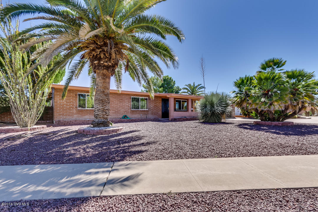 What a rare find... 3 Bedroom, 2 bath home with lots of bells and whistles. Enjoy the GORGEOUS views of the Santa Rita mountains from the spacious AZ room. Large master suite w/walk-in closet and ensuite master bathroom. 3rd Bedroom has pocket doors off the living room, ideal for a home office or den. Lots of extras including sunscreens on all South facing windows, newer Low E windows (except in AZ Rm), skylights and more! Lam wood floors thru out most of the home. Additional sewing area off the laundry rm AND a hobby workshop. NO popcorn ceilings & fresh paint inside. In the expansive backyard, you'll love the shed (with electricity) and the easy maintenance. Located on a spacious corner lot, you'll love the peace, privacy and resort lifestyle this Green Valley homes has to offer. In GV