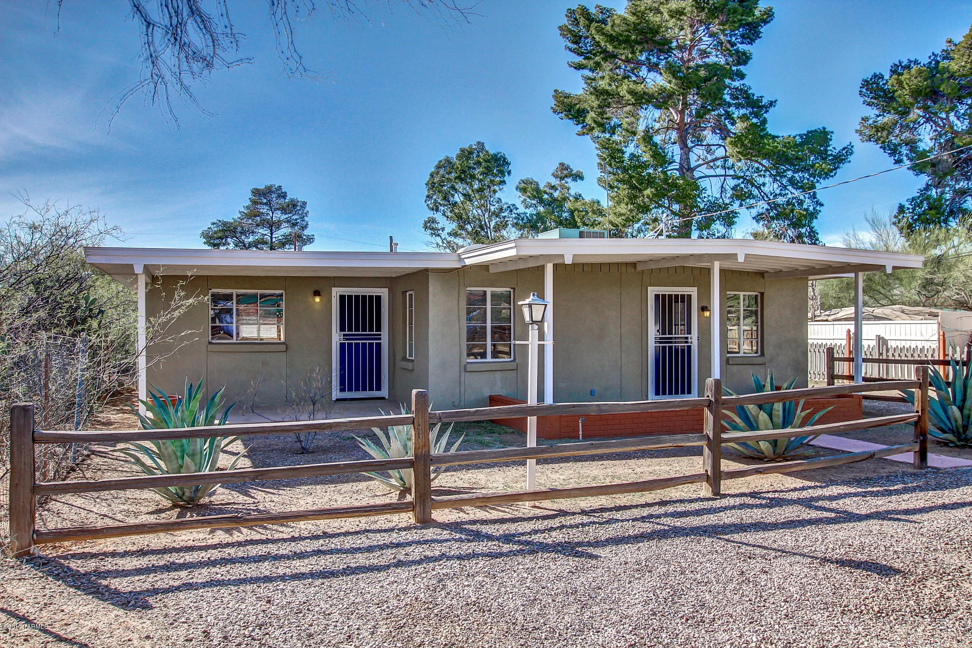 Charming 1940's Ranch Style Home with great curb appeal and front porch entry. Carefully remodelled by owner over the last four years, including HVAC, 200 amp electrical panel, water heater, new kitchen, bath, doors, floors and more. Beautiful tile floor throughout, large picture window, window blinds, crisp palette, period built-in shelves, and wall cutouts. Updated eat-in kitchen features white appliances, stylish counters, patio access, and wood cabinetry with hardware. Generous size bedrooms offer custom built-in closets, ceiling fan in 1 bedroom, and tastefully updated bathroom. Pedestal sink, designer tile, and fixtures. Enjoy the backyard covered patio, desert landscape, and endless blue skies.