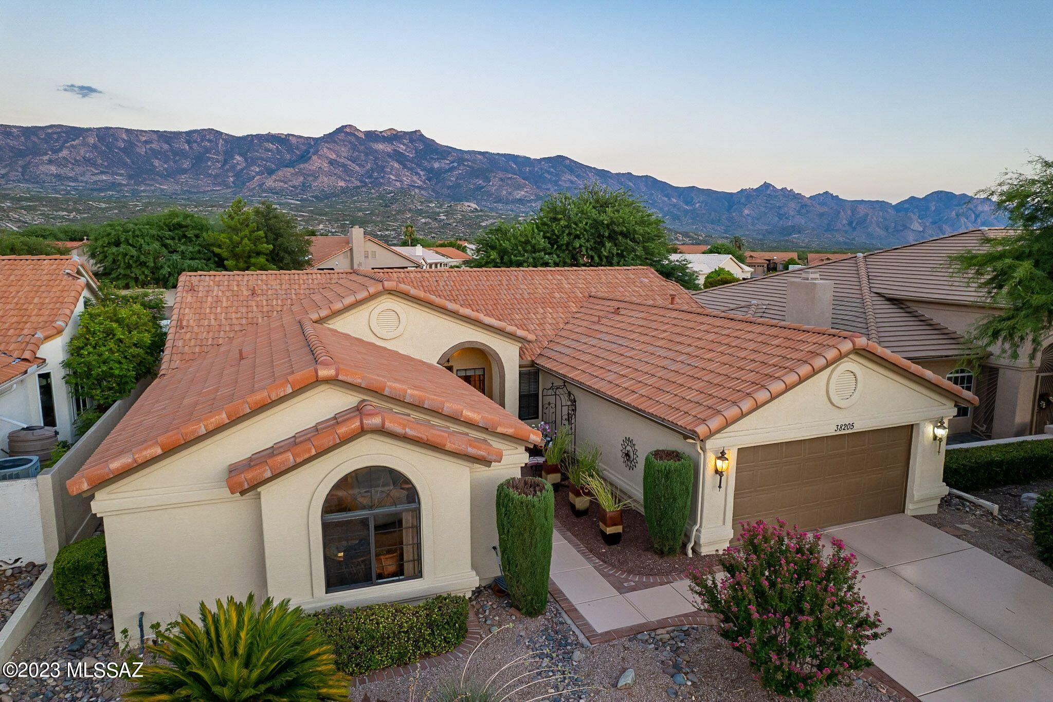 Three bedroom & three bath popular Topaz model boasts great mountain views from lovely, private backyard with expansive covered patio. Two bedrooms & two baths in main house plus attached casita with access from front courtyard or from inside of house. Could be used as a separate guest suite or left open as a third bedroom or office. Kitchen has stainless steel appliances, beautiful wood cabinets, wrap around tile counter with seating, nook with bay window and family room with vaulted ceiling and windows overlooking lush backyard. Covered rear patio. and lovely landscaping front and back. The garage is extended and has extra storage cabinets.