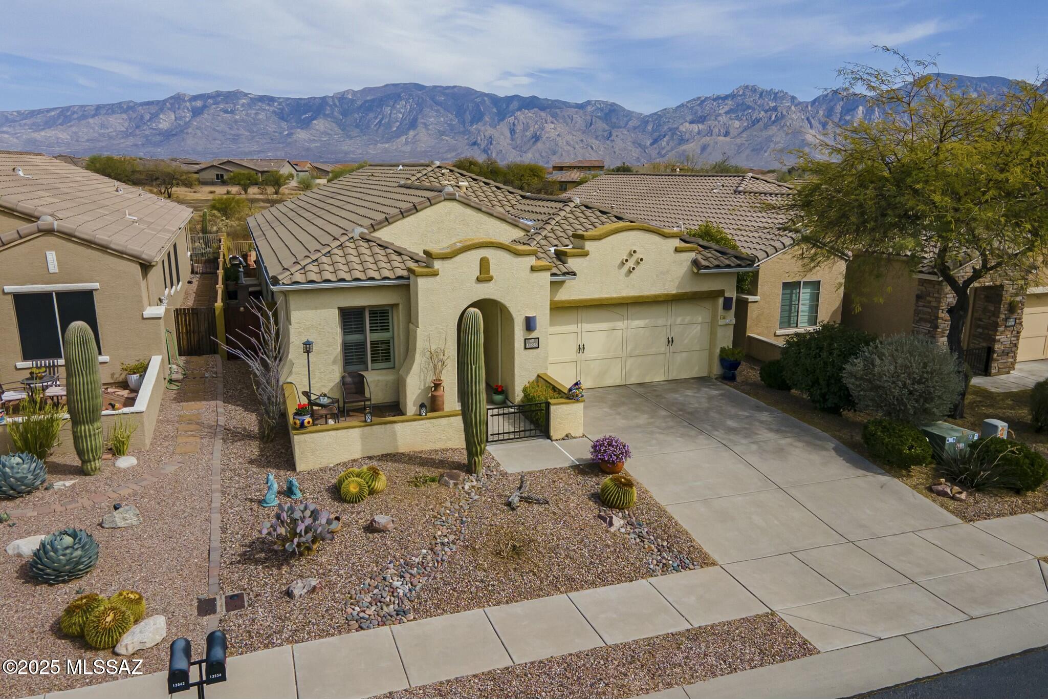 Fabulous (or Beautifully) updated 4BR 2BA on a premier lot in the Cortona neighborhood in the heart of Oro Valley. Breathtaking Catalina Views located on the former 14th fairway now transformed into the Vistoso Nature Preserve with walking trails. Natural desert green space with no rear neighbors. Convenient location close to shopping, fine dining, excellent schools, parks and entertainment. Enter the lovely courtyard opening to an open and inviting great room with room for a large entertainment center. Beautiful neutral tile on a diagonal, Upgraded fans and lighting, Plantation shutters. The kitchen features upgraded 42 in height cabinets with under cabinet lighting, granite counters, stainless steel fingerprint resistant appliances. The Primary suite features a large bay window with abundant natural light along with spectacular mountain views. Walking into the bathroom a double vanity, soaking tub and walk in shower are featured. A spacious vaulted closet offers abundant storage. 
The 2 car garage offers built in cabinets and a workshop area. 
Retreat to an unbelievable spacious backyard of unsurpassed mountain views. This entertainer's dream hosts a shaded patio with motorized sunshade and a custom beehive fireplace offering bench seating. Relax with the tranquility of the rock waterfall cascading into a refreshing spool on a built in timer on the flagstone paved patio.
Inviting you to enjoy breathtaking blue skies, sunrises and panoramic mountain views today! This gorgeous home may go quick! Lots of privacy in a very desirable neighborhood. A must see! Sellers are Motivated.