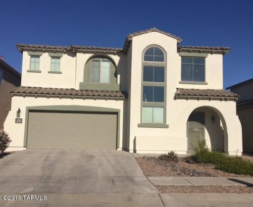 Why rent when you can own this light and bright home in the desirable north end of Rancho Sahuarita. This home has vaulted ceilings with a row of windows which captivate you the moment you walk in the door. The living room has a cozy fireplace and an area for a formal dinning room set. Down the hall is a full bedroom and bath, perfect for guests. Upstairs you'll find 3 additional bedrooms and a laundry room. The back yard offers plenty of privacy with no rear neighbors! With  all the amenities in Rancho Sahuarita including 3 pools, a splash pad, walking and biking trails and much more, this is luxury living at an affordable price. Don't miss seeing this home!