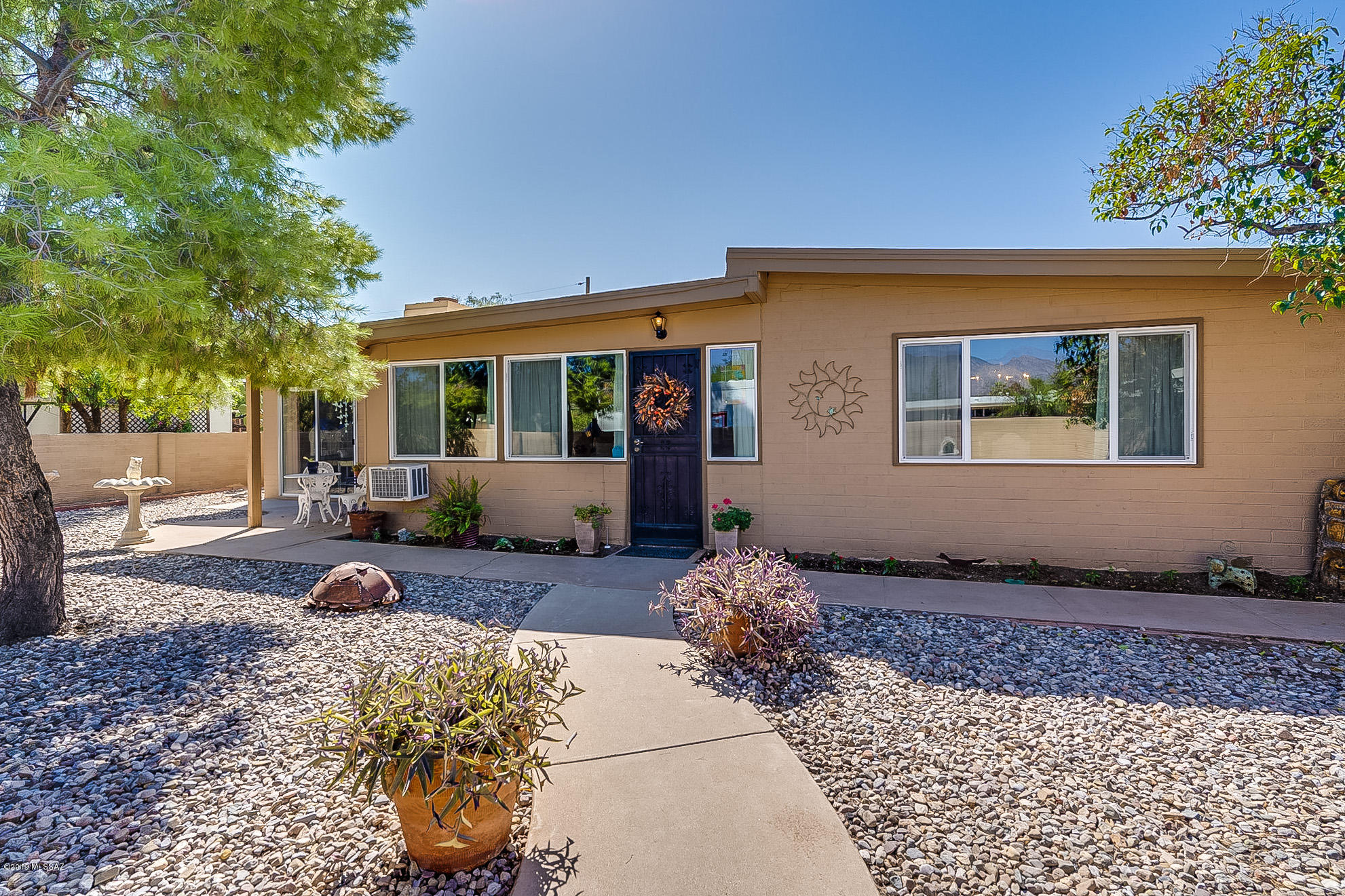 Charming 3 bedroom, 2&1/2 bath with a sizable bonus room and a beautiful Arizona room to enjoy the delightful Tucson weather. This home offers a split floor plan with a generous Master Bedroom and ensuite Master Bath. The living room boasts an enchanting stone fireplace and the kitchen has been recently renovated with designer touches. Enjoy the open floor plan, perfect for entertaining and family gatherings. Warm and welcoming with an abundance of natural light. Gorgeous mountain views, centrally located, within walking distance to a welcoming neighborhood park, and close to hospitals and shopping. Huge back yard with low-maintenance, well-kept landscaping. This is a charmer in the heart of mid-town!
Chandelier in Master bedroom and light fixture in Master bathe do not convey.