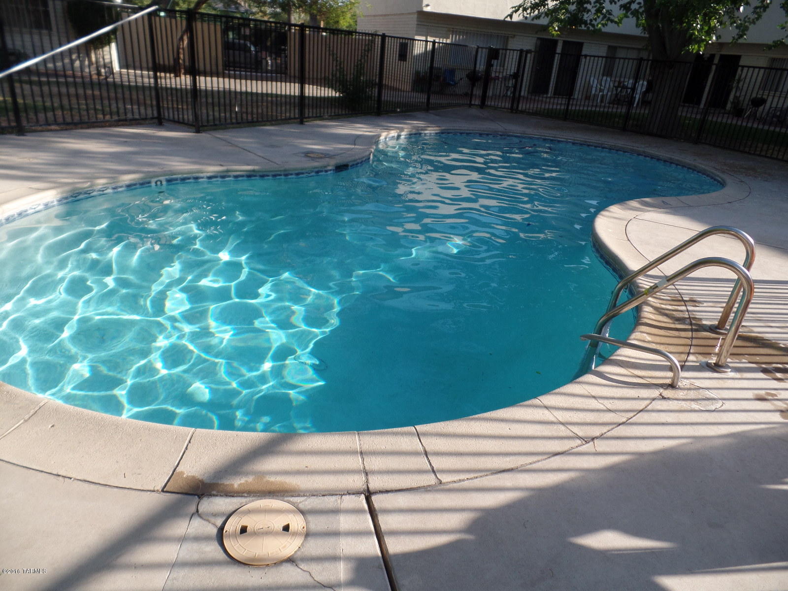 Gated community w. Pool! Walk to the U of A main gate! End Unit! Great property for Investors, U of A & Pima students and faculty. Close to 4th Avenue shopping & Downtown Tucson. Beautiful Saltillo tile, Brand new carpet, ceiling fans, large bedrooms, lots of storage. Brand new water heater in 2016. A/C & gas stove. Off street parking and on-site-secure bicycle parking area.  HOA fee pays for water, garbage & sewer, insurance, pool, Ramada, grounds, & common areas. NOTE: Two of the Sellers are members of the LLC & are licensed Realtors; one in the State of AZ & the other in CA. Condo is in very good, ''Turn-Key'' condition. Seller will pay for an HWA Home Warranty. Seller can accommodate a quick C.O.E. This is NOT a short Sale & NOT an REO property.