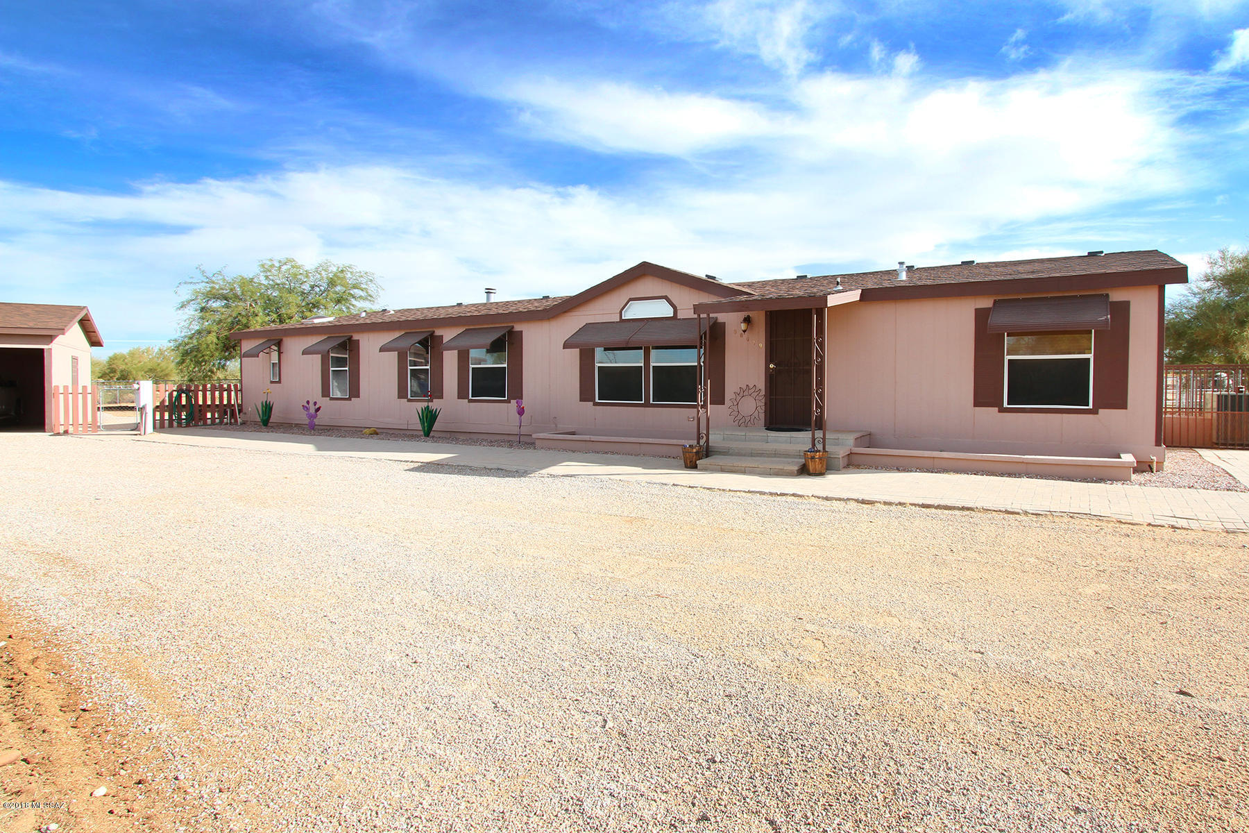 Equestrian Dream!!! This Charming & Immaculate property is completely professionally fenced with 2 turn outs,  7-Stall Barn w/lights & water, Tack Room and 2 Tack Up Areas, Hay barn, & lighted dressage arena area. State Land West & South of property for lots trail riding. The home offers 5 bedrooms 2 baths with Dinning area, living room, family room w/cozy fireplace, Master Bath has jetted garden tub, Master bedroom has walk in closet, laundry room, and nice size bedrooms.  Back yard is fence separately with covered patio and views of the horses. Great home for Equestrians, Family and Entertaining.  Owner is Licensed Realtor in AZ.