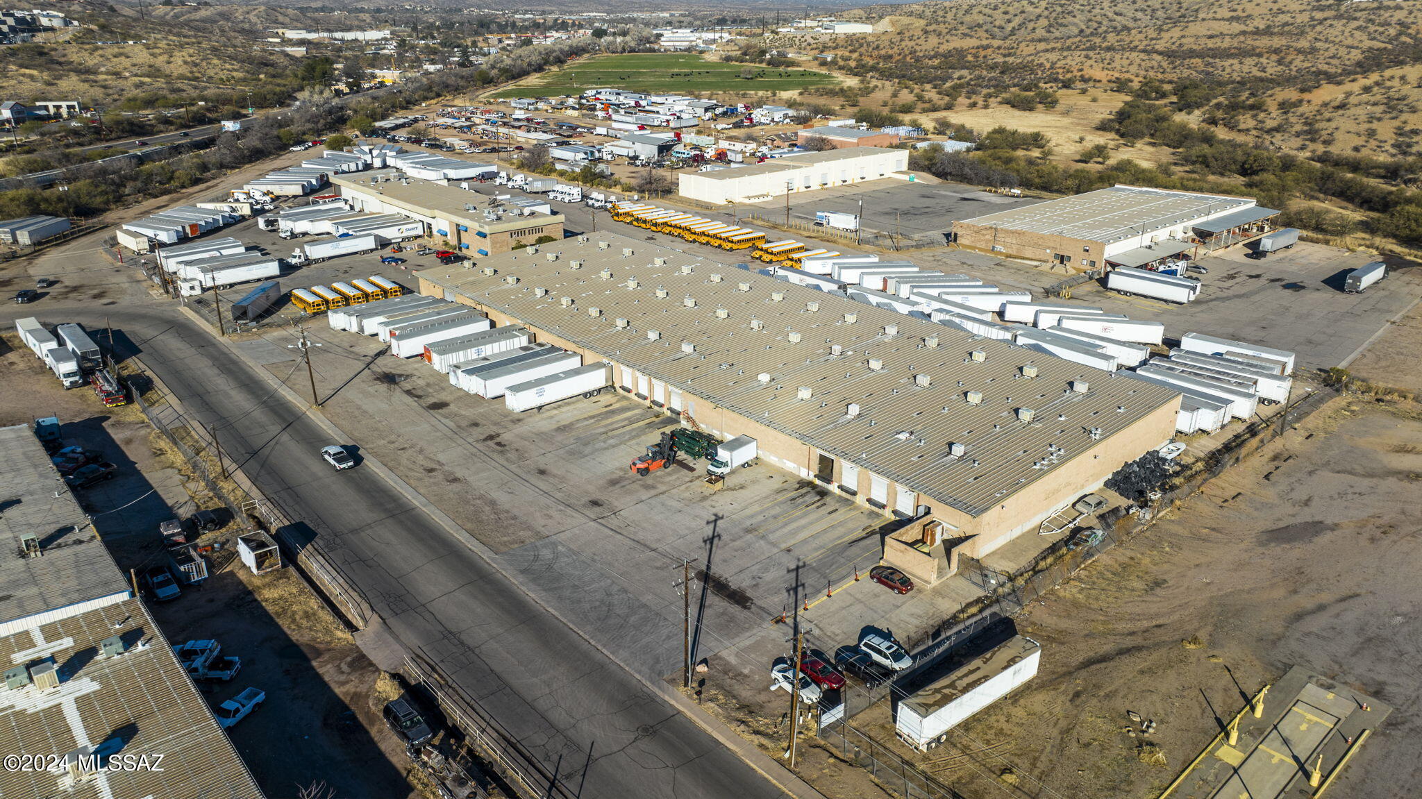 Over 75000 square feet of Industrial space in the heart of Nogales warehouse district which included 2 buildings.  Easy access of Grand Avenue.  Plenty of room for Truck turnaround! 10 loading and unloading bays allows trucks to move in and out quickly.  Approximately 45,000 sq/ft of open slab.  There is an office area inside the warehouse.