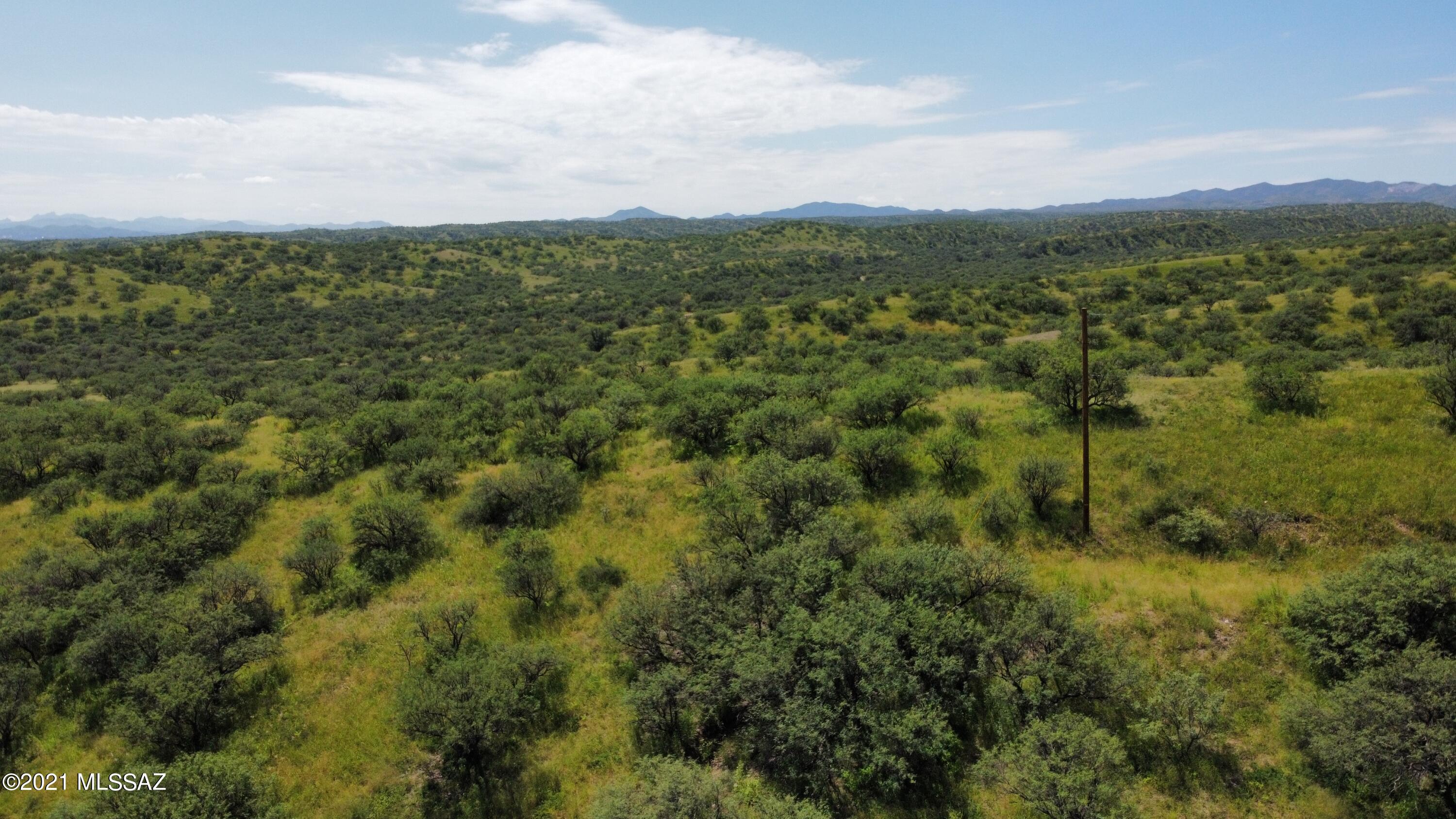 This is undeveloped sloped property  backs up to forest land.  Power at the lot line and water appears to be at street.  Buyer to verify.  Paved Rd to .1 mile of gravel rd.  Property has a wash down the right side of property from street.  A home at the top of the property will have  beautiful views and privacy.
