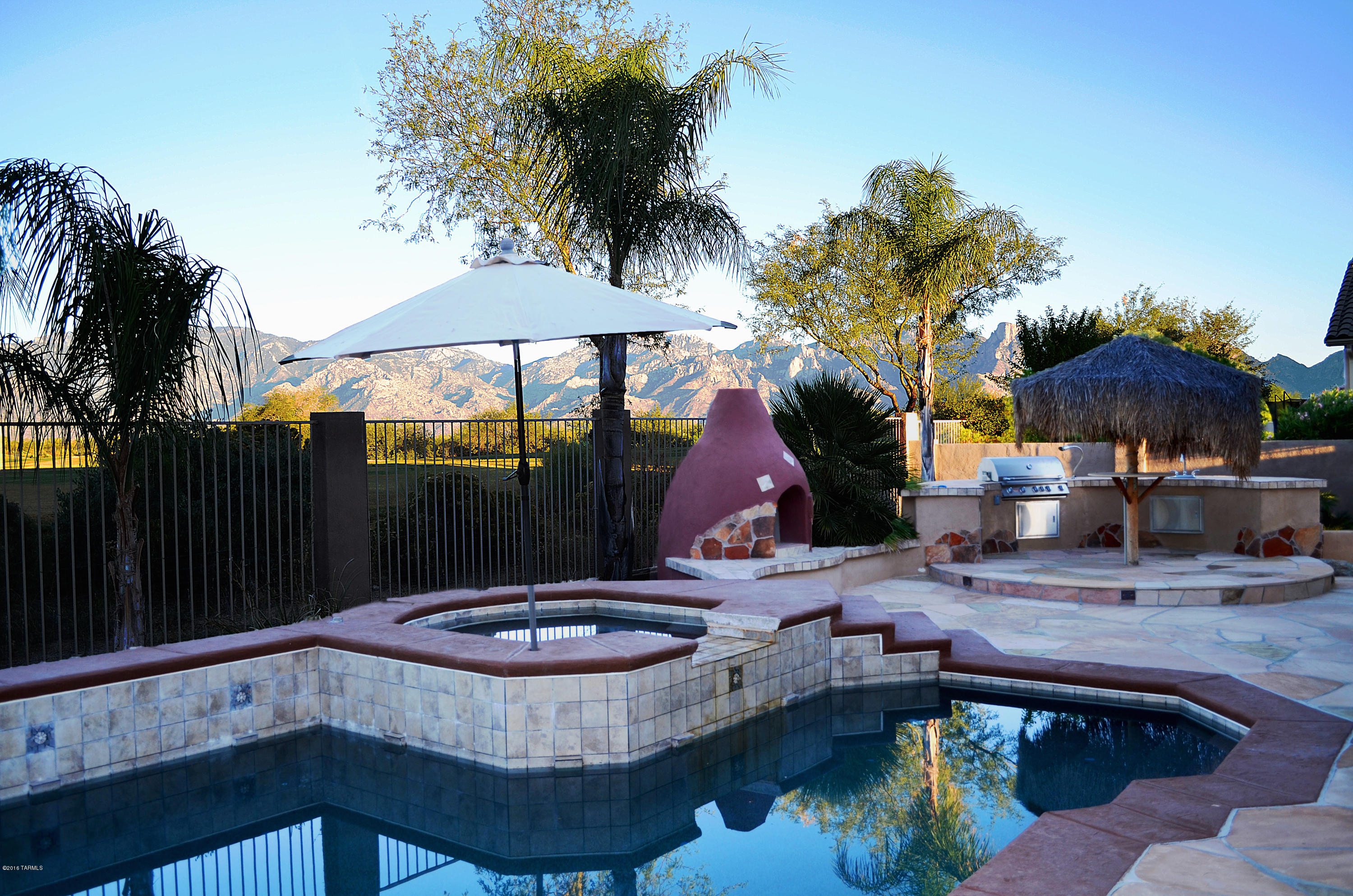 Grandeur embodied in this lovely semi-custom home in the desirable gated Siena Community. This 3 Bedroom/2 Bath home plus separate 1 Bed/1 Bath Casita is situated on a large premium view lot bordering Vistoso Golf Course and takes in stunning panoramic Catalina Mountain Views. Home boasts a large open great room w/ soaring 12 ft ceilings, cozy gas fireplace, built-in custom cabinetry, and wall of windows to enjoy the views. The gourmet kitchen has beautiful granite slab counter tops & backsplash, GE Monogram appliances, Cherry Cabinetry, prep-island, & breakfast bar seating. Retreat to the expansive Master Suite and spa-like bath w/ custom tile-work, jetted tub, separate shower, & 2 walk-in California closets. Treasure the superior outdoor living from this entertainers backyard w/ sparkling pool/spa/water feature, extended flagstone patio w/ banco seating, Kiva fireplace, Outdoor Kitchen w/ sink, grill, & Tiki Style Bar. See feature sheet in documents tab for full list of upgrades.