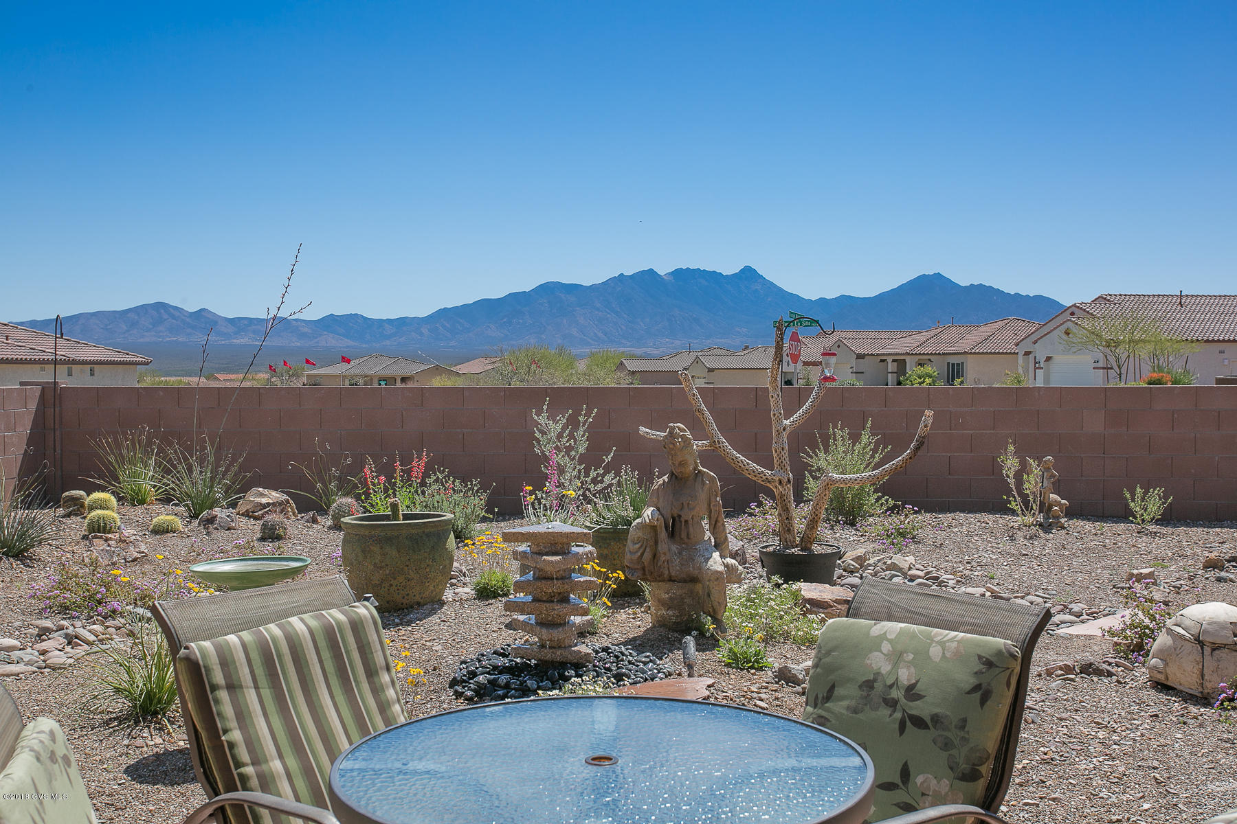 A Jewel in the Desert for the Discerning Buyer! Why wait 7-8 months to build a brand new dream home when its right here in the heart of Green Valley? Positioned perfectly to admire gorgeous mountain views, the Dorn built Catalina floor plan has countless upgrades! Lets start w/ the durable & beautiful cream of bordeaux granite C-tops throughout. Monsoon rains will easily be channeled away w/ rain gutters installed in front & back. Bountiful benefits come from the water filtration system/water softener. Hygienic & clean tile flooring throughout the entire home. As you are meditating, entertaining, or enjoying your favorite hobby, you'll revel in the magnificent Zen Garden while hearing music from the Surround Sound system. Electric Solar Screens for pleasant mornings! Simply Exquisite!