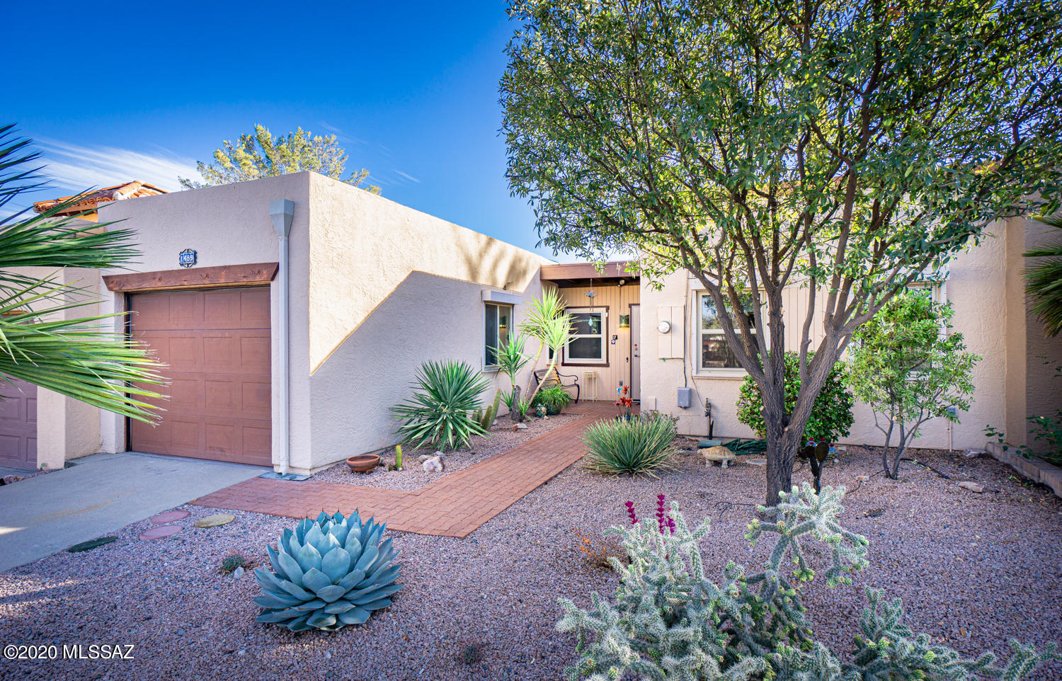 It's a keeper!  Enjoy the modest mountain view from your lovely back patio, low maintenance back yard and/or the fully enclosed Arizona room. Inside you'll love the partially updated kitchen,  beautiful Saltillo tile floors in the family room area,  newer windows and security doors, new stackable W/D, and double pantry! With split bedrooms and two baths, it's easy to entertain while enjoying some privacy as well! The kitchen cabinets, while original, are in good shape, and some have pull outs. There's a space in the kitchen to dine, or dine just off the kitchen in an area that is open to the family room. The double pantry has plenty of room for groceries and gadgets! Furnishings included. AZ room sq footage not included in total.  Seller to include a home warranty too!
