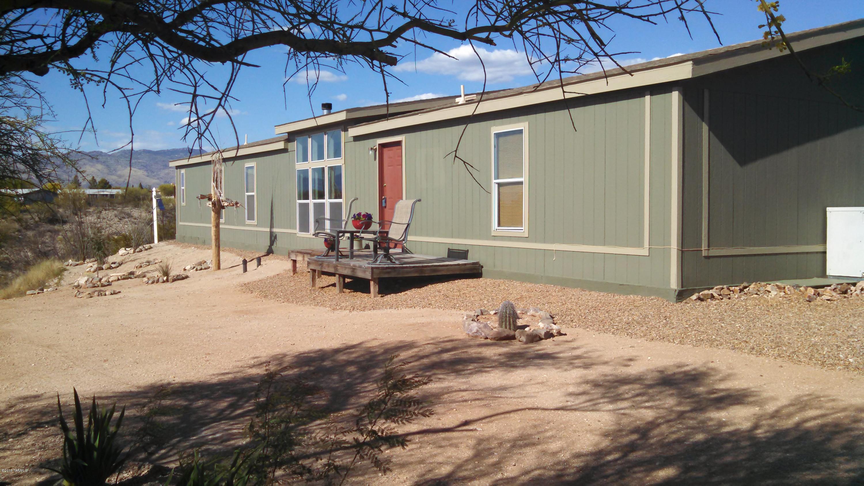 New listing in popular Vail Ranch! Borders Cienega Creek Preserve. Recently renovated, 2052 s.f. manufactured home on almost an acre. Located at the end of a cul-de-sac. Formal Living and Dining Rooms, Family Room with fireplace, 4 Bdrms, Breakfast area, kitchen island. Refrigerator included. Large Master Suite, huge closet, garden tub/separate shower, double vanity, Laundry Room. Fenced in backyard. Partially fenced lot. Amazing sunset, mountain and desert views! Newer carpet, roof, wood lam flooring, interior and exterior paint. Easy care landscaping. Plenty of parking. RV allowed. Paved streets, Vail Water, SW Gas, Septic. Close to Del Lago Golf Course. Award winning Vail School District.