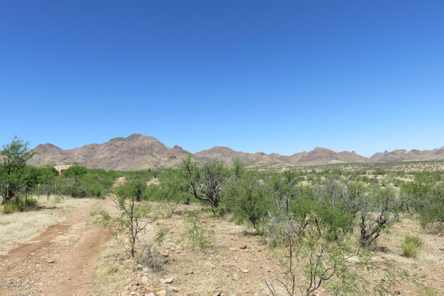 Nestled above Tubac in the hills of Aliso Springs with choice views of the Tumacacori Mountains to the Southwest and the Santa Rita Mountains to the East. Elevated 4.13 acre lot with flat building site.