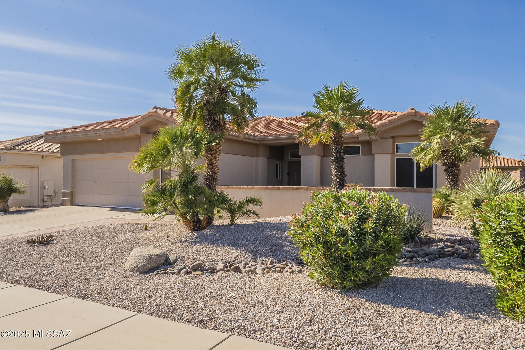Experience modern elegance and effortless living in this beautifully remodeled Sunrise Model, offering 1,818 sq ft of thoughtfully designed space with 2 bedrooms and 2 baths. Boasting an open-concept great room design, you'll love the natural light from its expansive windows, complemented by recessed lighting & stunning porcelain tile flooring. The gourmet kitchen has been tastefully updated with quartz countertops, an expansive breakfast bar, stainless steel appliances and white shaker-style cabinetry - making it a chef's dream kitchen. Relax in the spacious primary suite, featuring an en-suite bath with quartz topped dual vanity, soaking tub, tiled walk-in-shower and oversized walk-in closet. You'll also enjoy the Catalina Mountain views from the primary bedroom windows. The comfortable guest bedroom is conveniently located near the updated hall bath. Step outside to relax on the roomy back paver patio and enjoy some Catalina Mountain views. You'll love this space for entertaining, too! In the front courtyard, you'll also enjoy expansive mountain views. All furnishings are available for purchase under a separate bill of sale. You'll want to begin your active adult lifestyle in this exceptional, one-of-a-kind home!  Don't miss out - schedule your private showing today!