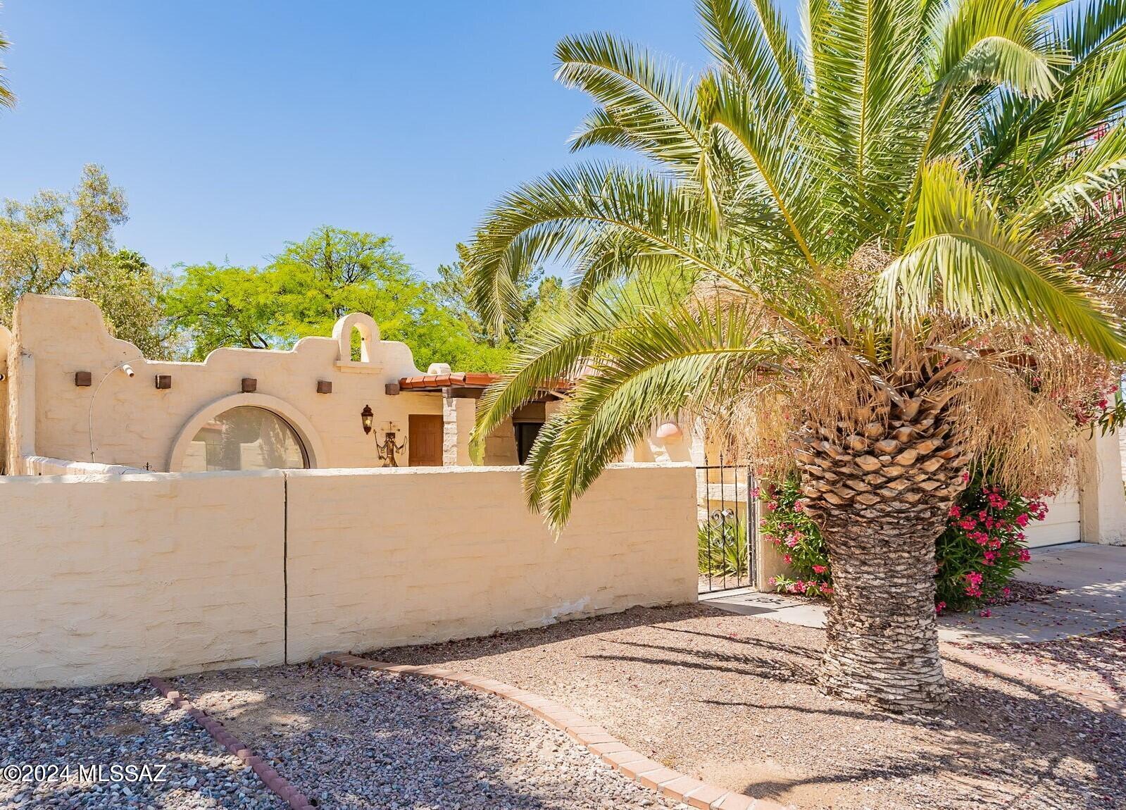 A classic Whigham-built home with Alamo-style architecture, Spanish arches, and a textured adobe-style exterior, complete with a bell tower, is waiting for you!  The energy-efficient 8'' block construction not only keeps utility costs down but also provides a quiet and comfortable living environment.  Step inside and be welcomed by the bold Southwest colors and decor, which give the interior a warm and inviting ambiance. The focal point of the living room is the traditional beehive fireplace and the large arched window with views out to the attractive front courtyard.   The solid-surface flooring throughout the home ensures ease of maintenance and adds to the modern feel of the space while natural light floods in through skylights, creating a bright and cheerful atmosphere. The super large primary bedroom is a true retreat, featuring a patio door that opens to a beautiful wrap-around patio where you can soak in the Arizona sun, enjoy your morning coffee, or relax at the end of the day.  Located on a quiet street, this townhouse offers the added benefit of being just moments away from the community pool, where you can unwind and socialize with neighbors.  Living in Esperanza Estates is about more than just the house.   The community offers an array of amenities, including a refreshing swimming pool, pickleball courts, a wood-fired pizza oven, nine lush parks, and about one and a half miles of scenic walking trails.  Embrace the joy of easy living in a community that caters to all your retirement needs - It's a lifestyle!