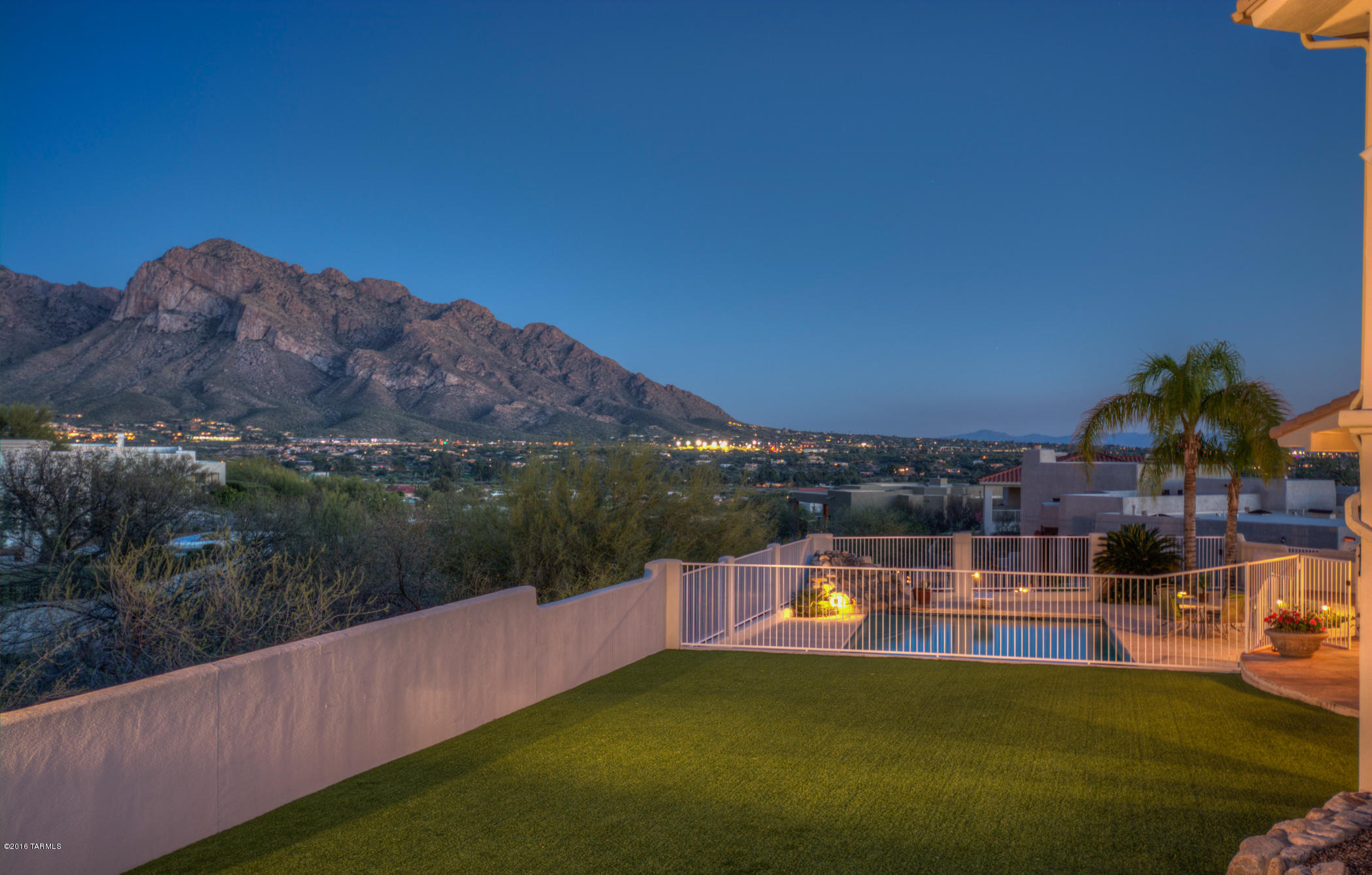 A magnificent custom family home with spectacular views of the Catalina Mountains,Pusch Ridge and the city lights. Owner built this rare 6 bedroom plus den/office, 5 bathrooms, downstairs media/rec room and 3 viewing decks. New main floor Master Suite w/sitting room, large walk-in closet,seamless shower and soaking tub. 2nd Master Guest quarters upstairs. Open gourmet kitchen with soaring picture windows, breakfast bar and nook. New granite countertops throughout.Storage pantry and large laundry room. Home is steel constructed so no termites! All copper pipes, artificial grass and maintenance-free exterior. Sparkling 12 ft deep pool with diving board and water feature. This beautiful Custom home is located in the luxury gated community of Canada Hills Estates.Close to shopping and schools.