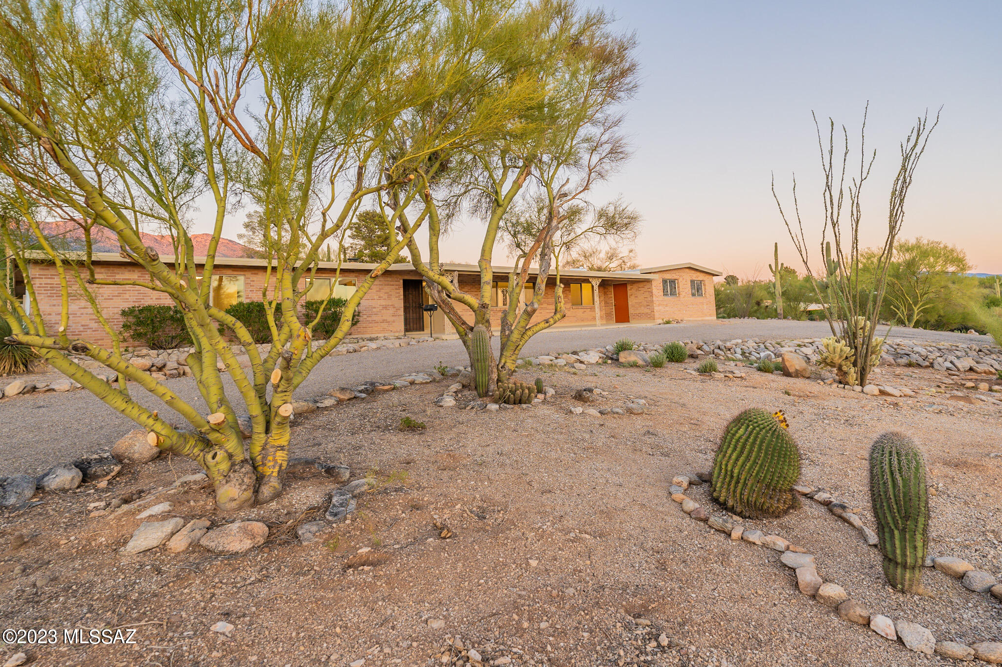 Nestled in the Catalina Foothills, this 4-bedroom residence is a harmonious blend of modern elegance and timeless design. Boasting two primary suites or an en-suite guest quarters in the split plan, the interior showcases a seamless fusion of luxury and comfort. The heart of the home is a spacious living area that effortlessly flows into a chef's kitchen adorned with walnut cabinetry and complemented by white granite counters and top line Gen Air appliances—a perfect setting for culinary enthusiasts. Meticulously updated, the residence features thoughtful details throughout, offering an abundance of natural light and a serene ambiance. Stepping outside, a sparkling pool awaits, set against a backdrop of breathtaking mountain views, inviting you to enjoy the pinnacle of desert living.