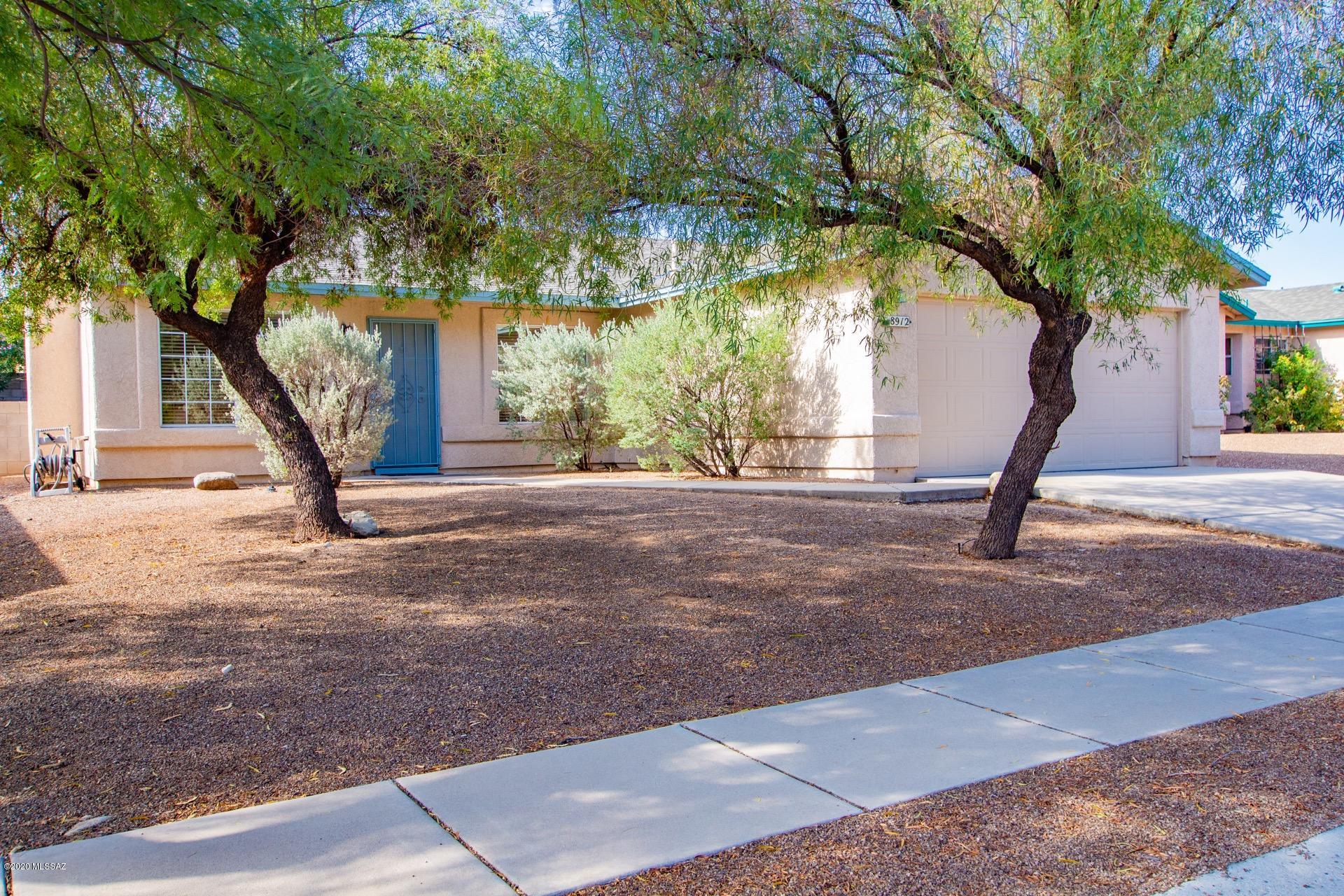 Step into this charming & inviting home and notice its soaring ceilings, soothing palette and cozy fireplace.  This home comes with handsome laminate wood floors in the living room, ceiling fans, & window blinds throughout. Enjoy the breakfast bar, SS appliances, neutral tiled floor, & plenty of white kitchen cabinets w/hardware. Perfect location near parks, shopping, schools and golf course.  Formal dining area has upgraded lighting, & French doors to patio from family room. Master bedroom boasts laminate wood floor, 2 closets, & private en suite bathroom w/dual sinks, designer mirrors, & lighting. Make use of the outdoors with the covered patio, desert plants, synthetic turf, & paver patio for dining. Come and see today! Will not disappoint!