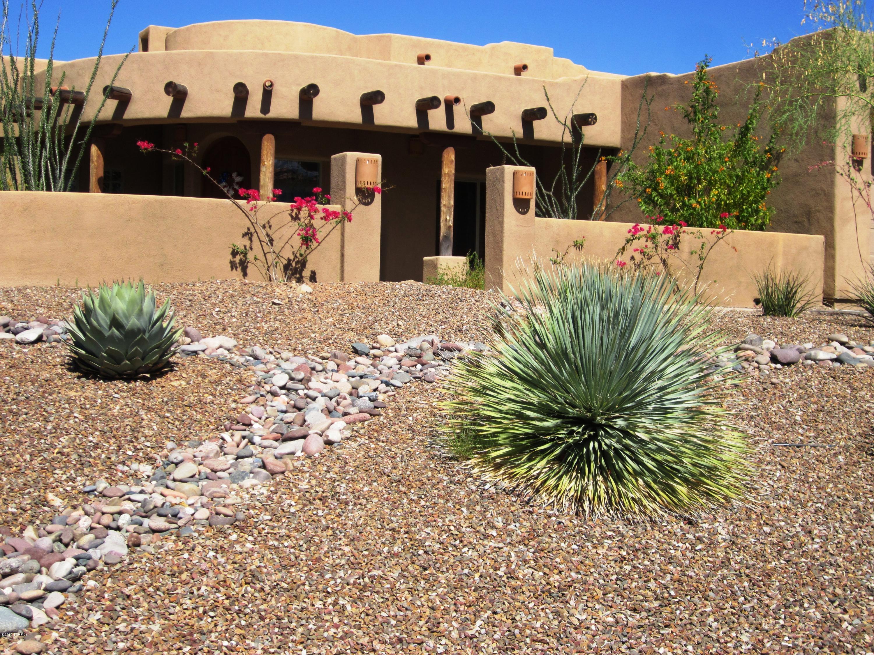 Spectacular views from this beautiful home in gated Pusch Ridge Vistas. Colored concrete floors throughout with slate in baths. Formal living/dining room. Viga beam & wood ceilings in great room. Master suite w/a sitting area & F/P. Seperate vanities & closets in master bath w/garden tub. Kitchen boasts granite counters, hickory cabinets and stainless steel appl. incl. dbl. oven. Enjoy outside living while in awe of mountain/city views. 3 car garage.