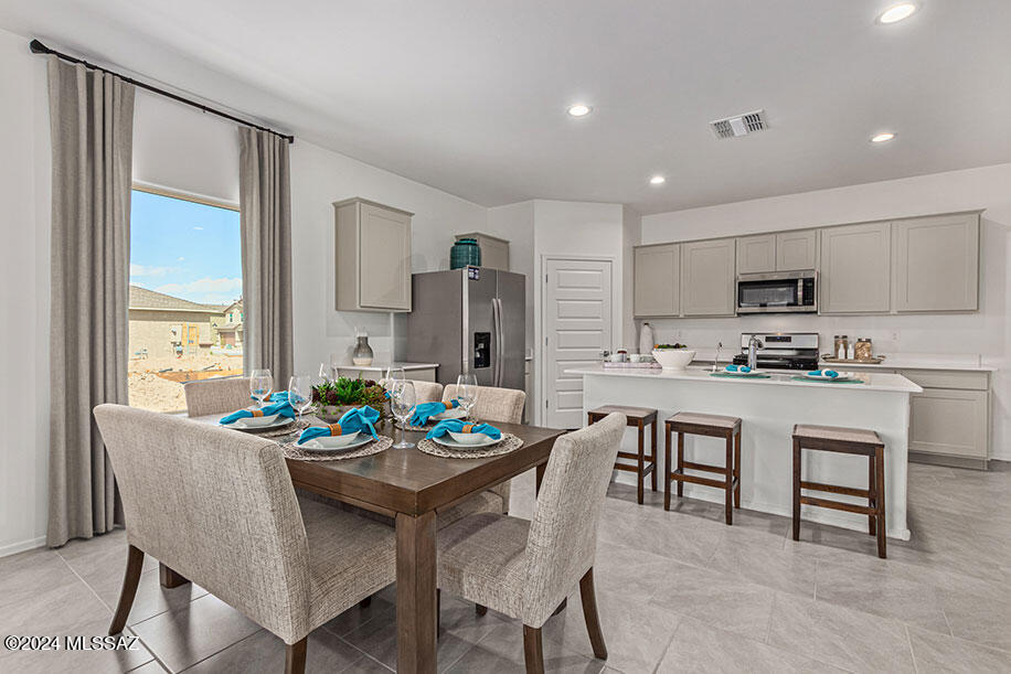 Welcome to Senita Crossing, where spacious living meets convenience! Our newest Tucson community boasts this open floor plan ideal for modern living. Enjoy the perks of a community park just steps away, with easy access to I-10, DMAFB, TIA, University of Arizona, and Downtown Tucson. Inside, you'll find a host of premium features, including stainless steel appliances (microwave, dishwasher, gas range), walk-in pantry, white shaker cabinets, granite countertops, and tile flooring in most areas. Say goodbye to cold showers with a tankless water heater and embrace the future with smart home technology. Plus, enjoy the convenience of water filtration at the kitchen sink and the added efficiency of a radiant roof barrier. Don't miss out on the opportunity to make Senita Crossing your new home!