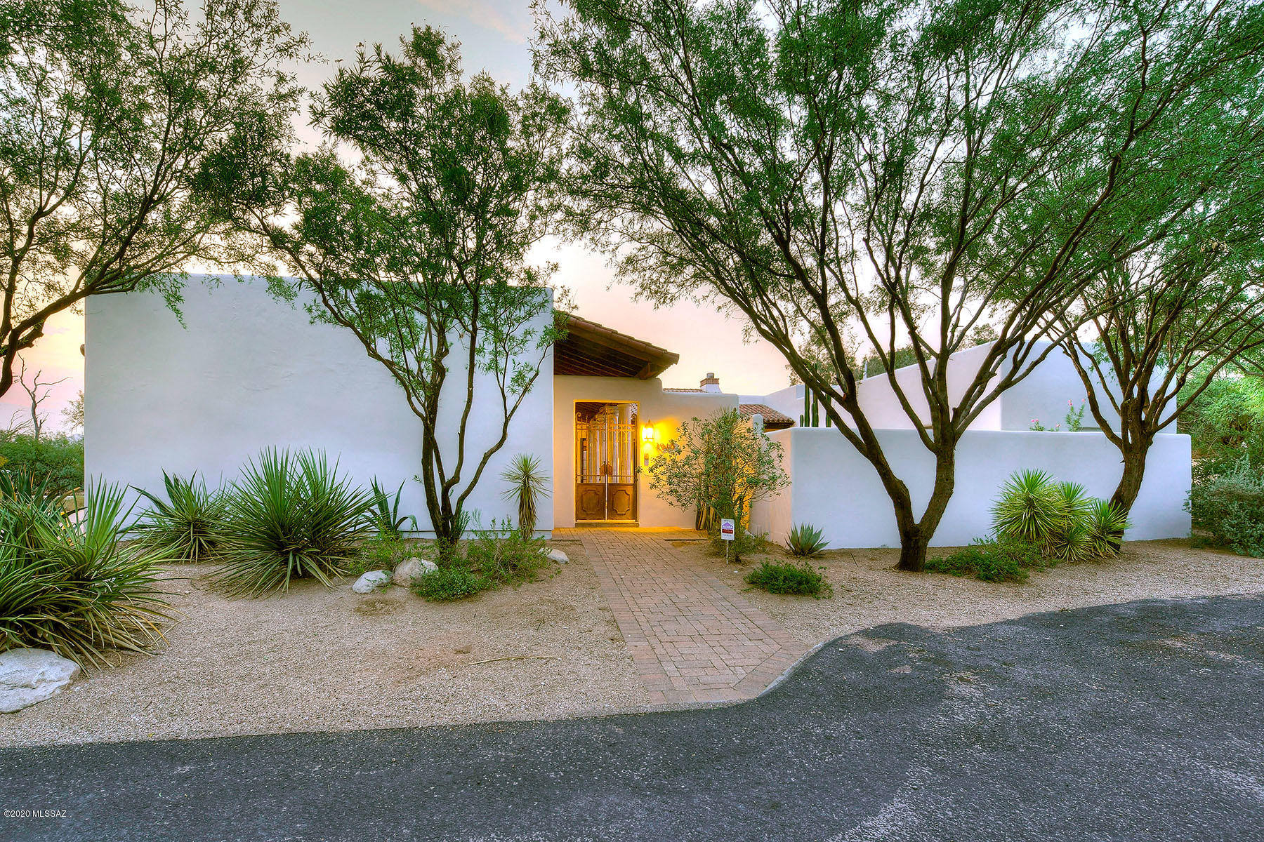 Splendid custom home is a Spanish and Mission revival Hacienda specifically designed for entertaining. The kitchen is a chef's dream with Viking double ovens, Viking range with pot filler, travertine tile imported from Italy.  Sub Zero fridge,  Caesar Stone counters and custom cabinets round out this stunning kitchen.   The great room features exposed truss and beams and a large 2 way fireplace.  This beautifully designed room has french doors on both sides that can opened to the backyard and  courtyard for entertaining and bringing the beautiful desert ambiance inside.  12 foot ceilings add to the openness.  The bedrooms are oversized, including the master bedroom.  Master bathroom has steam shower and jet tub.  There is a library with built in shelves and fireplace. Entire hom homes has new stucco and paint on the exterior.  This subdivision is where Merle Norman's estate is located.  There is a community BBQ area and a walking trail that is beautiful among all of the mature trees.  This home is a must see with all of it's special upgrades.