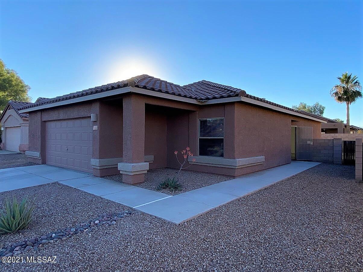Beautifully updated and maintained 3 bed/2 bath home in desirable Northwest Tucson in the Gladden Farms area. This home features updated tile flooring throughout living spaces and kitchen, updated vanity in bathroom, new water heater, updated appliances, generous 2 car garage w/ extra space for storage and large backyard with decorative rock ready for you to put your personal touches on it! This is a must see home that would be perfect for a small family. See it quick before it is gone!