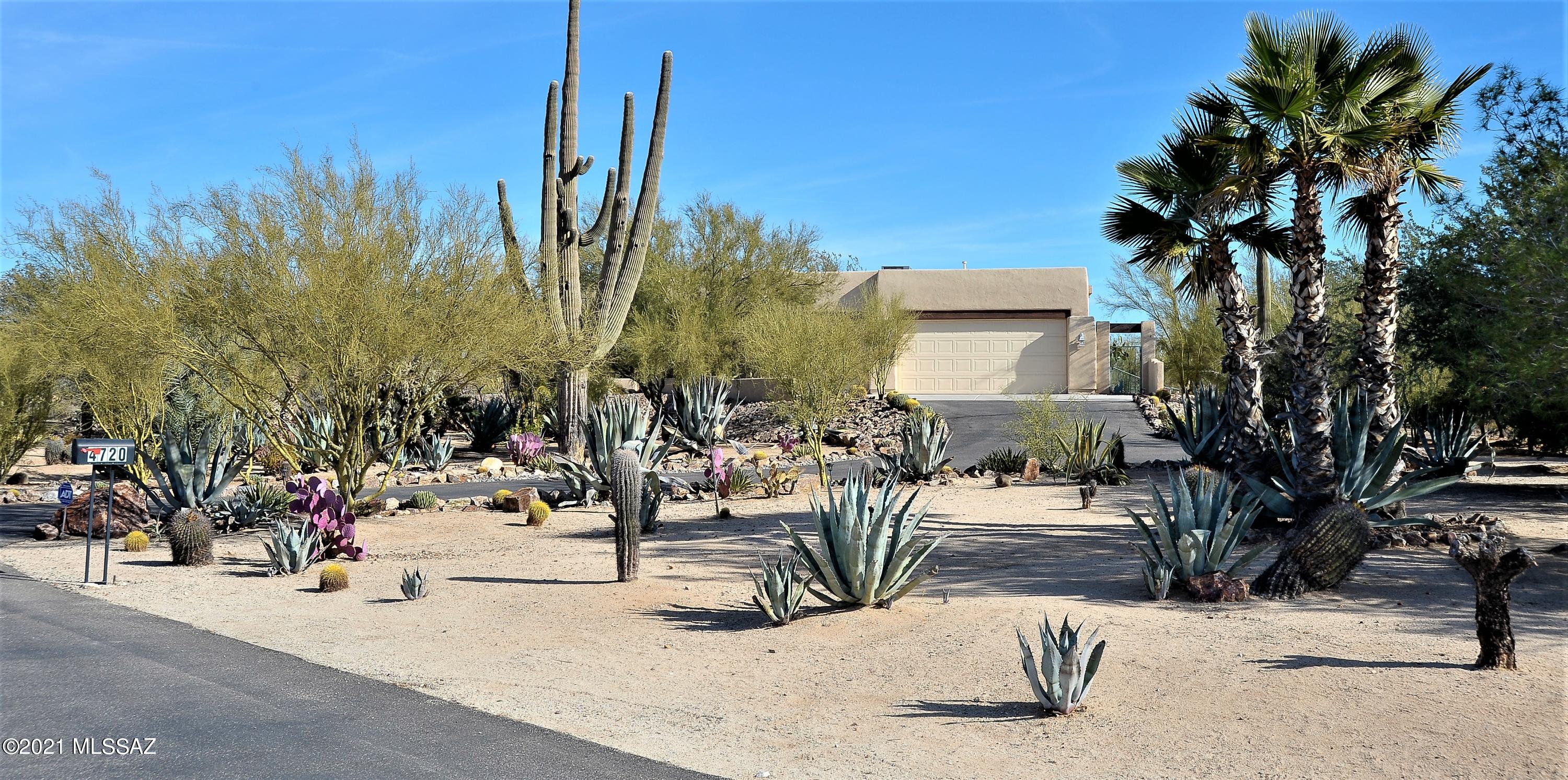 Custom desert oasis tucked away on a private 3.3 acre lot just off Oasis Rd. Spacious great room & split bedroom floorplan. 4Br, 3Ba plus den/office & formal dining room. Oversized east facing patio overlooks lush desert area with mountain views. Peaceful, private, serene. No visible neighbors. Large kitchen boasts Alder cabinets with granite counter tops, gas cook top and huge, walk in pantry. 18'' tile throughout (no carpet). Jack & Jill bath between two bedrooms. Amazing variety of desert vegetation including over 40 saguaro spread around the property. Views abound with the Catalina Mountains to the east and Sombrero Peak to the west. Don't miss the mini-orchard to the right of the driveway. Great NW location feels remote although minutes to shopping & I-10.
