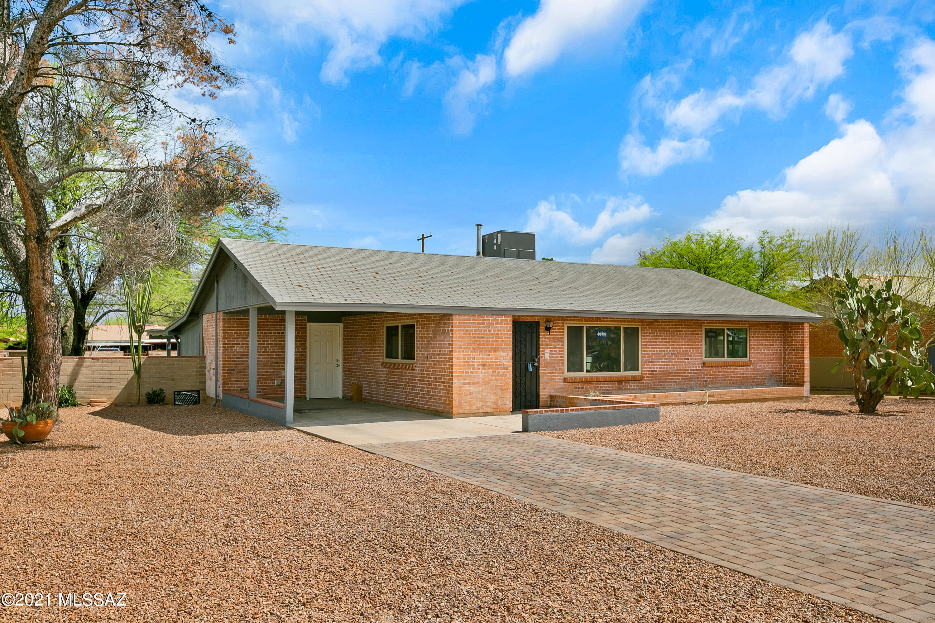 PRICED TO SELL! Spacious brick home on a QUIET MANICURED street close to the U of A , Banner/UMC, & Blenman Elementary on a quarter acre lot. Great contemporary kitchen with quartz countertops, undermount stainless farmhouse sink, glass door upper cabinets & built-ins ++ enhance the mid-century architecture. Appliances include stainless steel French door refrigerator, dishwasher & range. Beautiful stained concrete floors! Owners suite has vaulted ceilings and an updated ensuite bathroom. 2nd and 3rd bedrooms are oversized. There is a spacious familyroom with a wall of windows featuring panoramic views. New double pane windows and LED lighting. The walled-in yard features a HUGE covered patio and backyard access to the alley. Generous side yards.. Please submit offers by Mon. 5-24 4:00 PM.