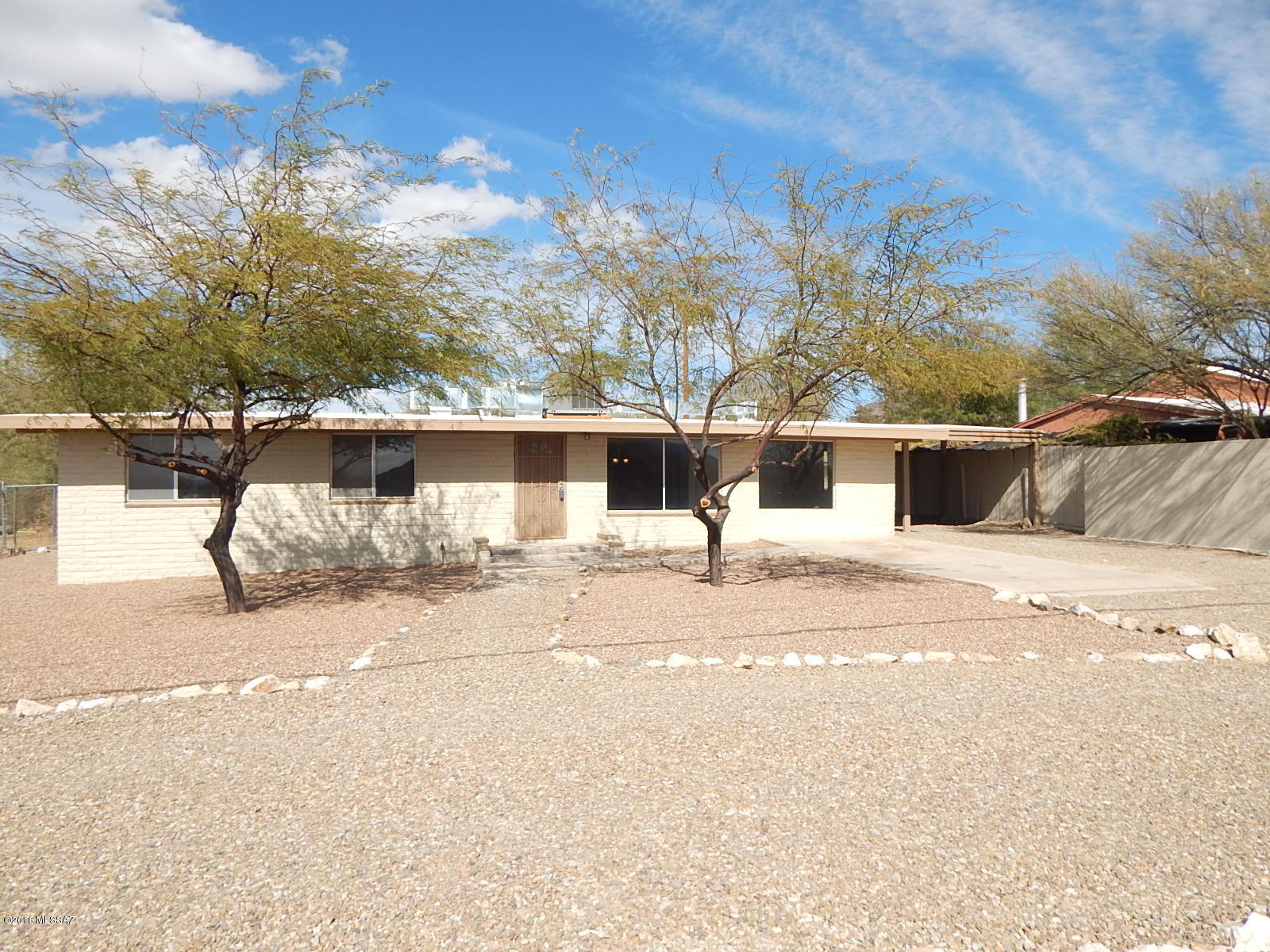 PRICE JUST REDUCED! Beautiful and recently updated slump block home with circular driveway located in Southwest Tucson. With 1431 sq ft of living space this home has 3 bedrooms, 2 bathrooms, spacious kitchen with breakfast bar, new stainless steel appliances, beautiful back splash & Quartz counter tops. Both bathrooms have new vanities, mirrors & beautiful new tile shower surrounds. Also has large backyard with covered patio great for entertaining, carport & huge laundry room.<FONT COLOR=RED> Recently painted interior and exterior, installed NEW ROOF, NEW AC, NEW beautiful tile flooring in all the right places & new carpet. </FONT>Come see this home before its gone. Call Agent for more details.