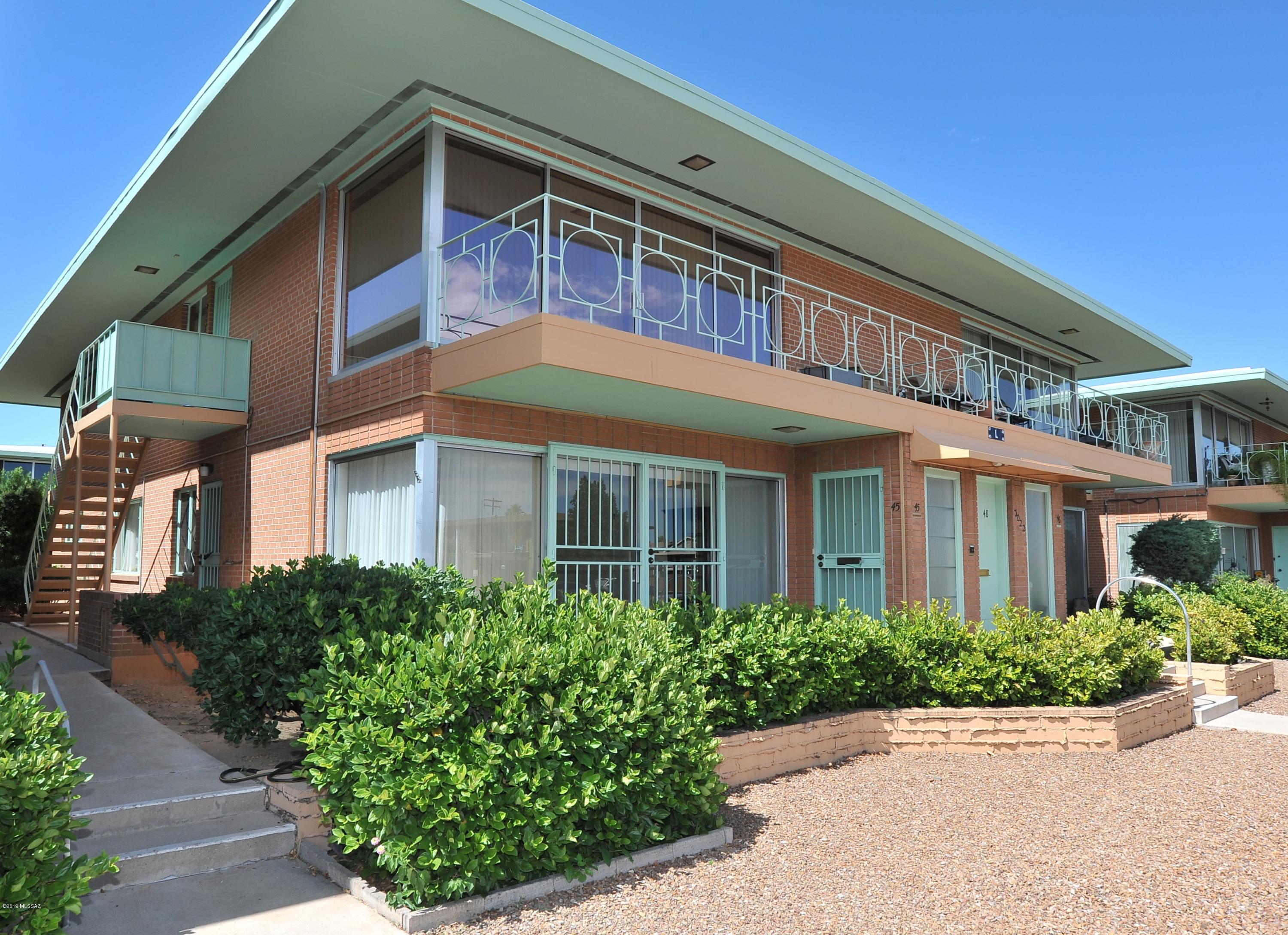 Lovely ground floor condo in the prestigious Sam Hughes neighborhood. Villa Catalina Apartments is honored with National Register of Historic Places designation because of its distinctive Mid-Century design and opulent landscaping. Sunny living room with huge windows. Freshly painted interior. Wood laminate floors and new carpet. Oak cabinets in kitchen and guest bath. Murphy bed and built in office furniture in guest bedroom. Hall closet has washer hookup. Shady patio faces the pedestrian-friendly common area. HOA fee, which would be lower for owner-occupant, covers property tax, utilities, heat, AC, trash pick up, heated pool, pest control, exterior maintenance, most plumbing and electrical. Age restricted; must be 55+. Do you prefer a second story mountain view? See 3020 E 6th St, G-28.