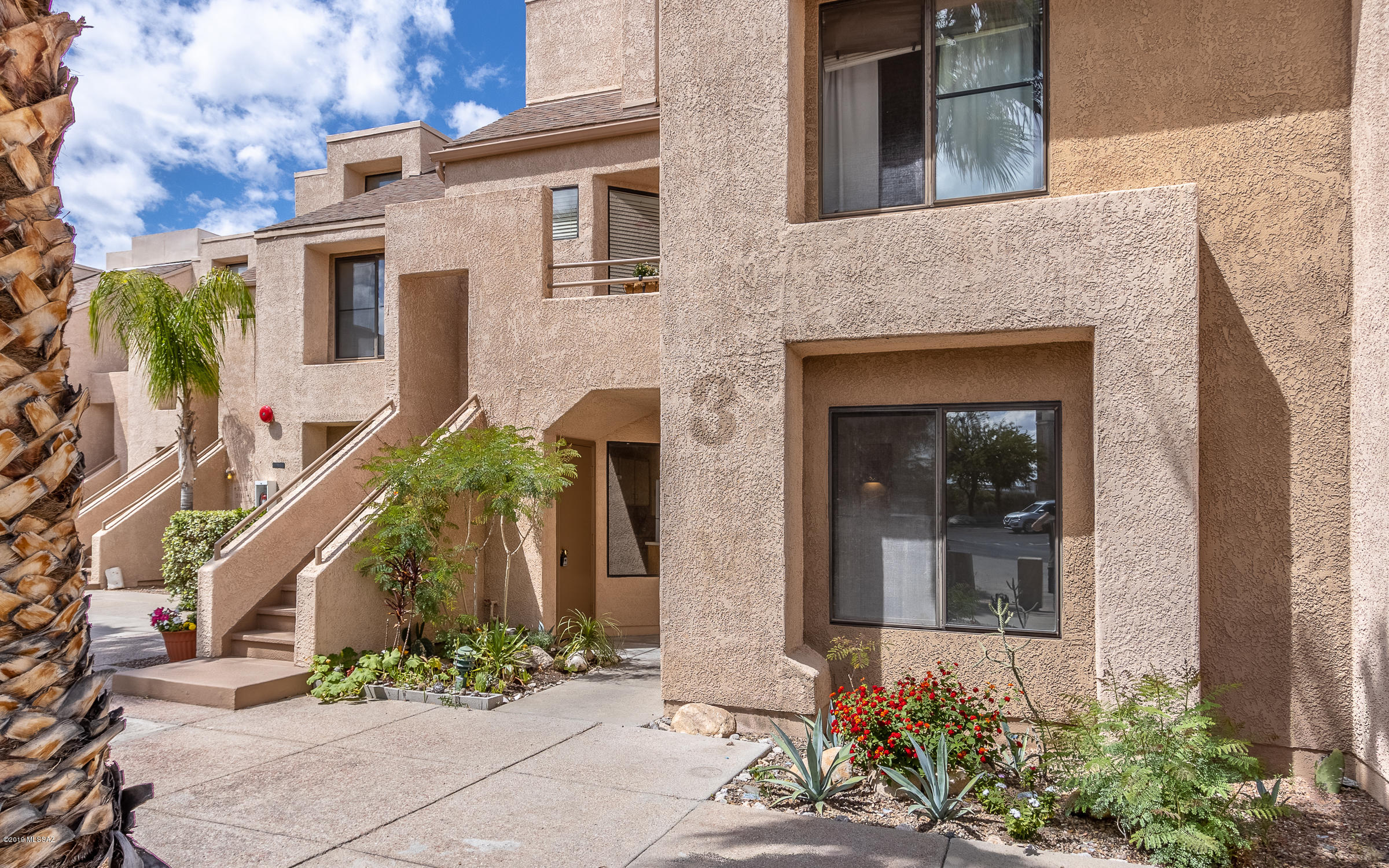 GROUND FLOOR Unit, NO one behind you, just VIEWS of the Santa Catalina Mountains and Natural Desert. This 2 Bedroom/2 Full Bath is a split floorplan, has high ceilings, Wood-Burning Fireplace, Tile Floors in Great Room and Kitchen, NEW Carpet in Bedrooms and has recently been repainted. Kitchen has Breakfast/coffee Nook, lots of cabinet space, good storage, and counter space. ALL the Appliances convey. Master Bedroom has amazing views of the mountains, two closets, covered patio access and a large full bath. The GATED Desirable Dakotah Hills Condo Community offers Privacy, (Heated) Swimming Pool, 2 Spas, Location Convenient to Shopping, Restaurants, other services, & District 16 Schools. HOA fee covers water, sewer, trash, rural metro fire, pool,2 spas and exterior maintenance. EZ SHOW-Go!
