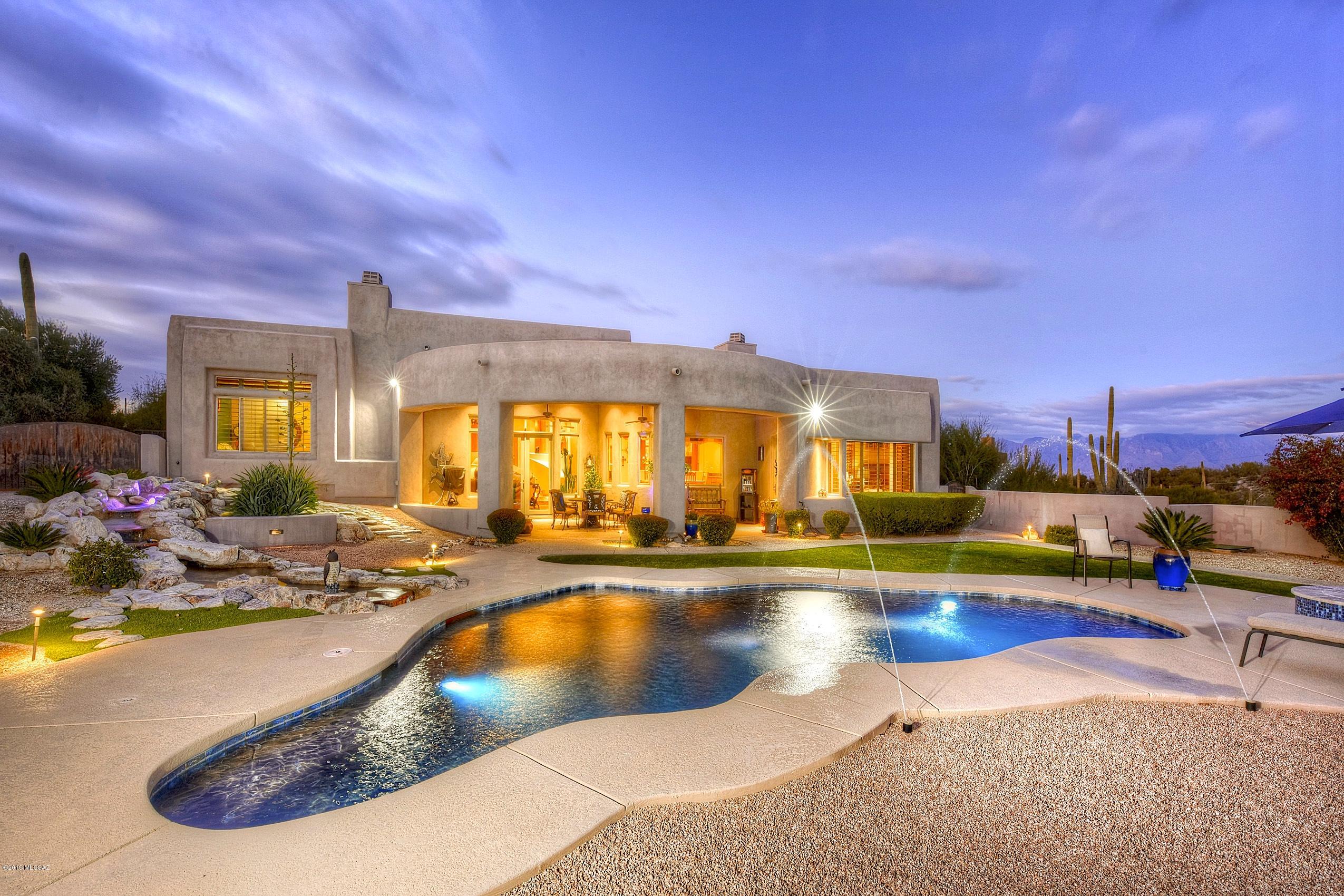 This unique west-side property has stunning views over all of Tucson and combines the excitement of being near campus/downtown with a calm sense of detachment and relaxation. Full of high-end finishes and outstanding craftsmanship. This home has not only all of the expected luxuries (granite counter tops, Stainless steel appliances, Etc.) but also unexpected and more subtle touches like softly lit niches and cozy fireplaces.
It has a huge 3-car garage with built-in cabinets and a workbench that is any craftsman's dream. This hidden desert sanctuary in a private gated community just minutes from the University of Arizona, the Starr Pass golf course, and the University Medical Center. Will move quickly; come see today!