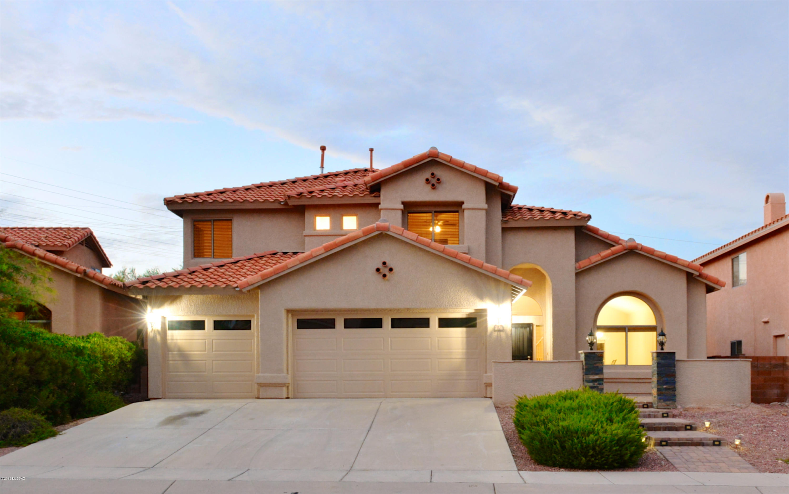 Simply stunning home! Freshly painted inside and out! Handsome curb appeal with slate accents on pillars. Welcoming courtyard with great mountain views! High ceilings, new lighting and new door hardware throughout! Beautifully remodeled kitchen with contemporary white cabinets, new granite counters, SS appliances, pendant lighting over island & corner kitchen window. Gas range, roomy pantry, brushed nickel pulls! Gas fireplace in great room w/French doors out to back yard. Pool fenced, artificial grass & covered patio. Very private lot will welcome family and guests alike. Master suite w/double doors, wood laminate flooring, French door to balcony. Walk in closet, soaking tub & separate shower. Downstairs bedroom & full bath. This is a great floor plan!