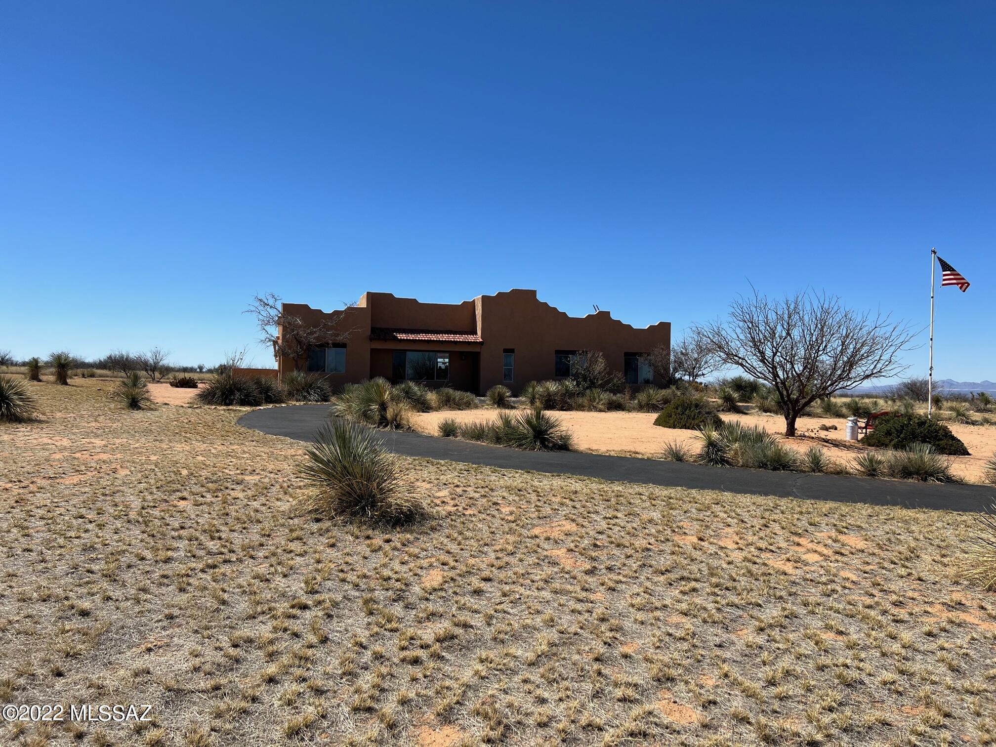 Beautiful Santa Fe style home with exposed beams (Vegas).  Concrete floors, lots of windows for a very open feeling.  Awesome room off the master bedroom, great retreat area.    Outstanding views in all directions. . Sit out on the deck and enjoy the sunrise, sunsets, and the majestic Cochise Stronghold or watch the  lights of distant cities.  The home has desert easy care plantings and a grey water system to water them. Check out the automatic doggie door, opens by magnetic collars on your dog. This is a beautiful home at a great price. Dragoon Mountain Ranch is a gated subdivision with 36 acre parcels, there are CC&R's and an HOA that maintains the roads.